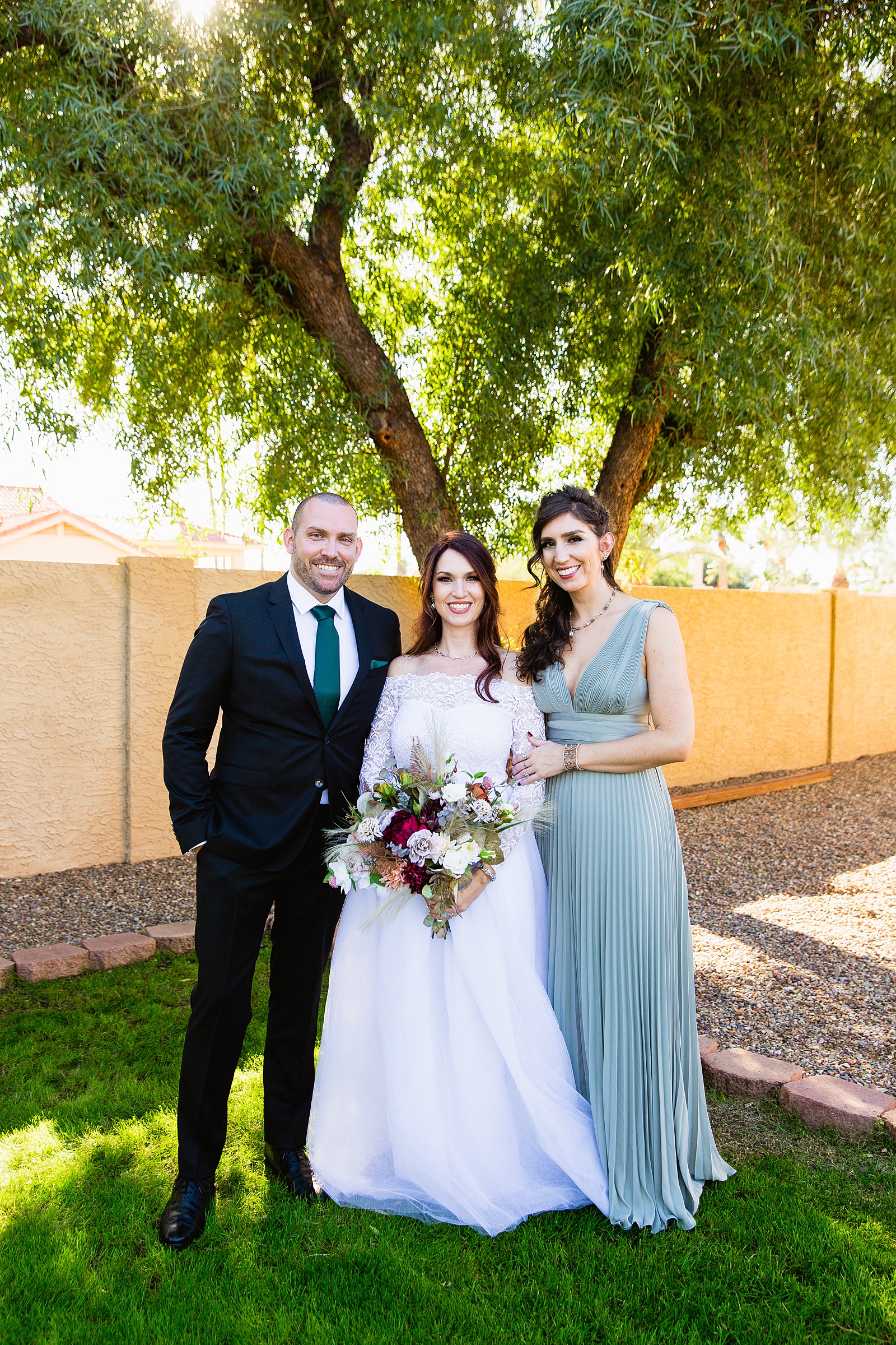 Bride and mixed gender bridal party together at a Backyard Micro wedding by Arizona wedding photographer PMA Photography.