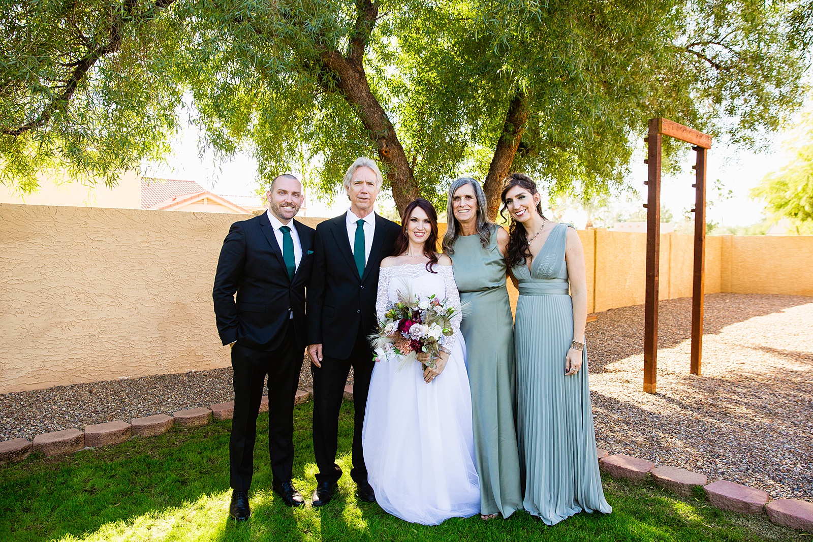 Bride with her family at a Backyard Micro wedding by Arizona wedding photographer PMA Photography.