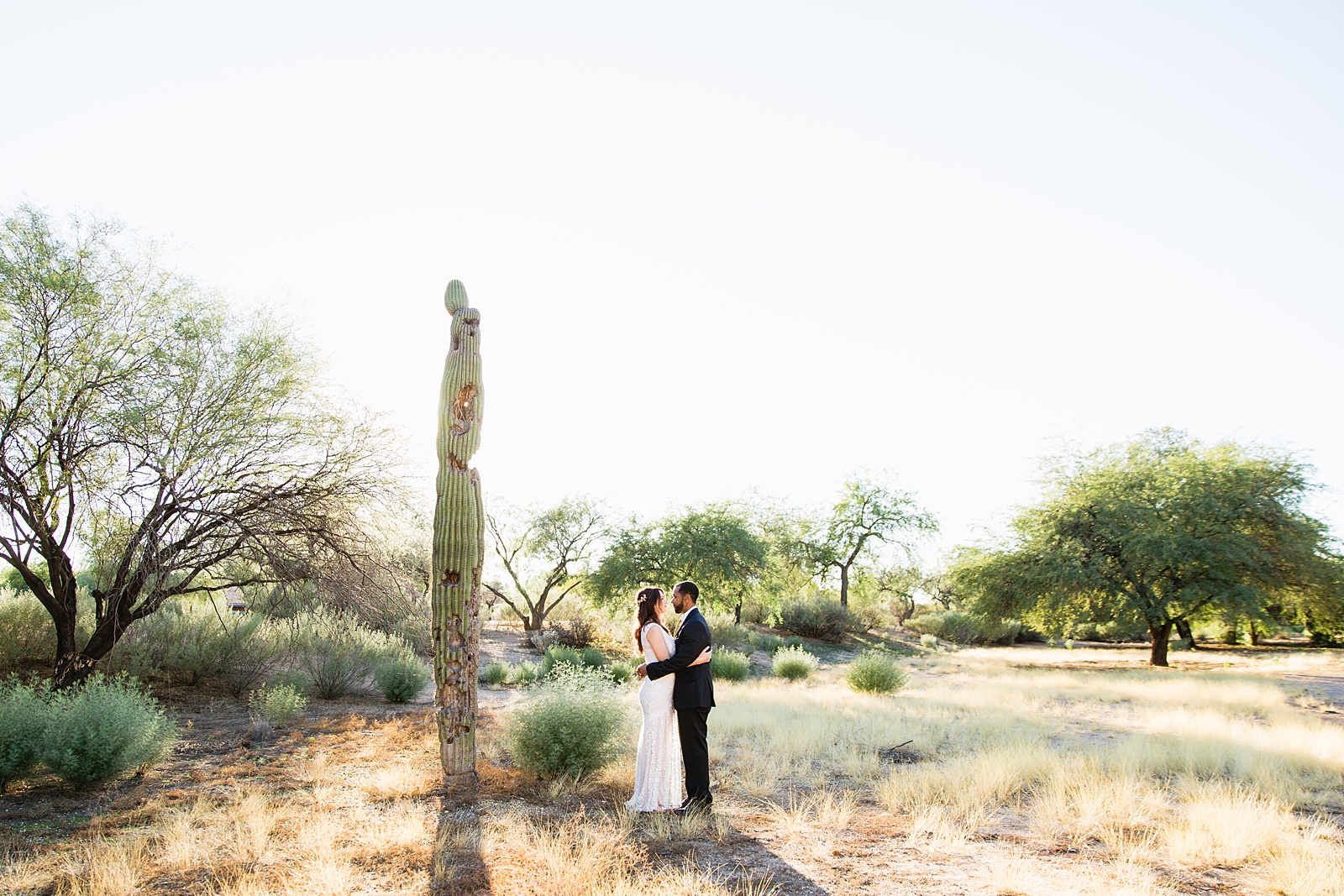 Bride and groom pose for their Backyard Micro wedding by Scottsdale wedding photographer PMA Photography.