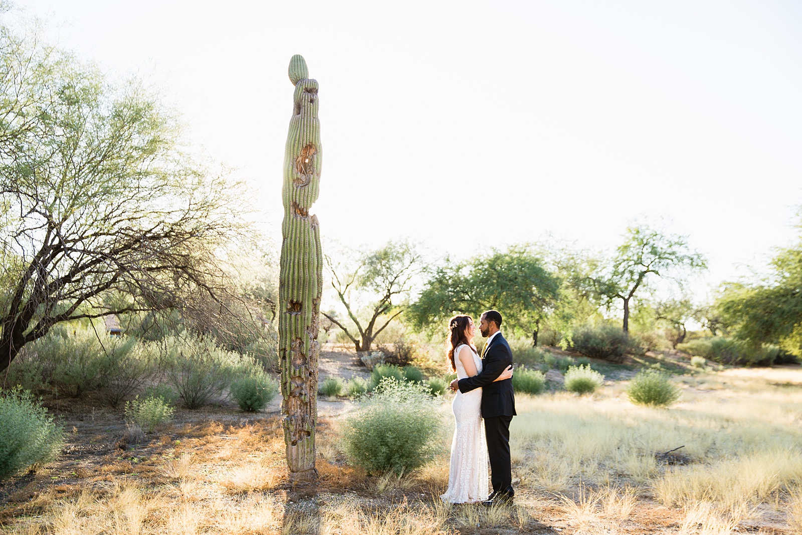 Bride and groom pose during their Backyard Micro wedding by Arizona wedding photographer PMA Photography.