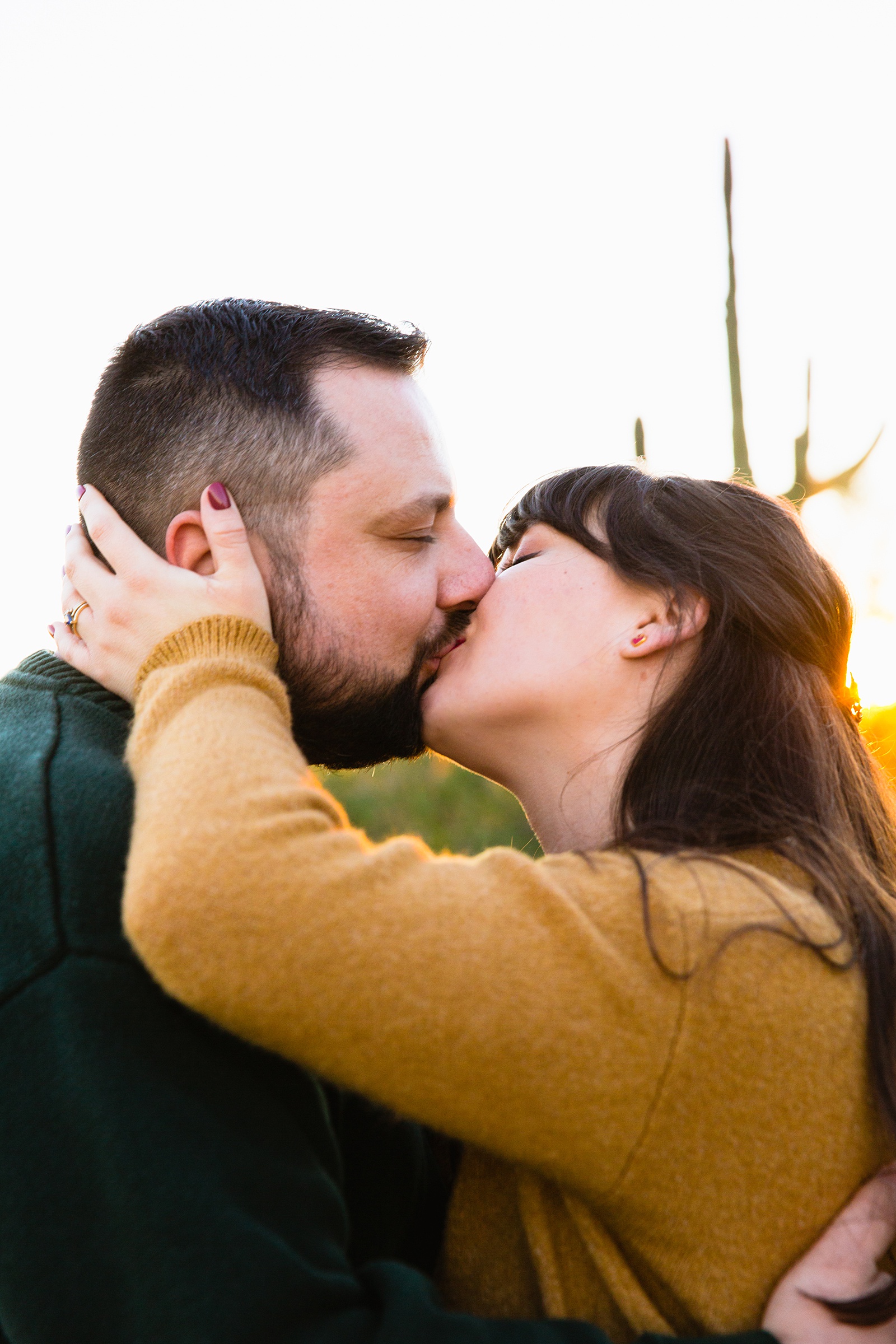 Couple share a kiss during their Papago Park engagement session by Phoenix wedding photographer PMA Photography.