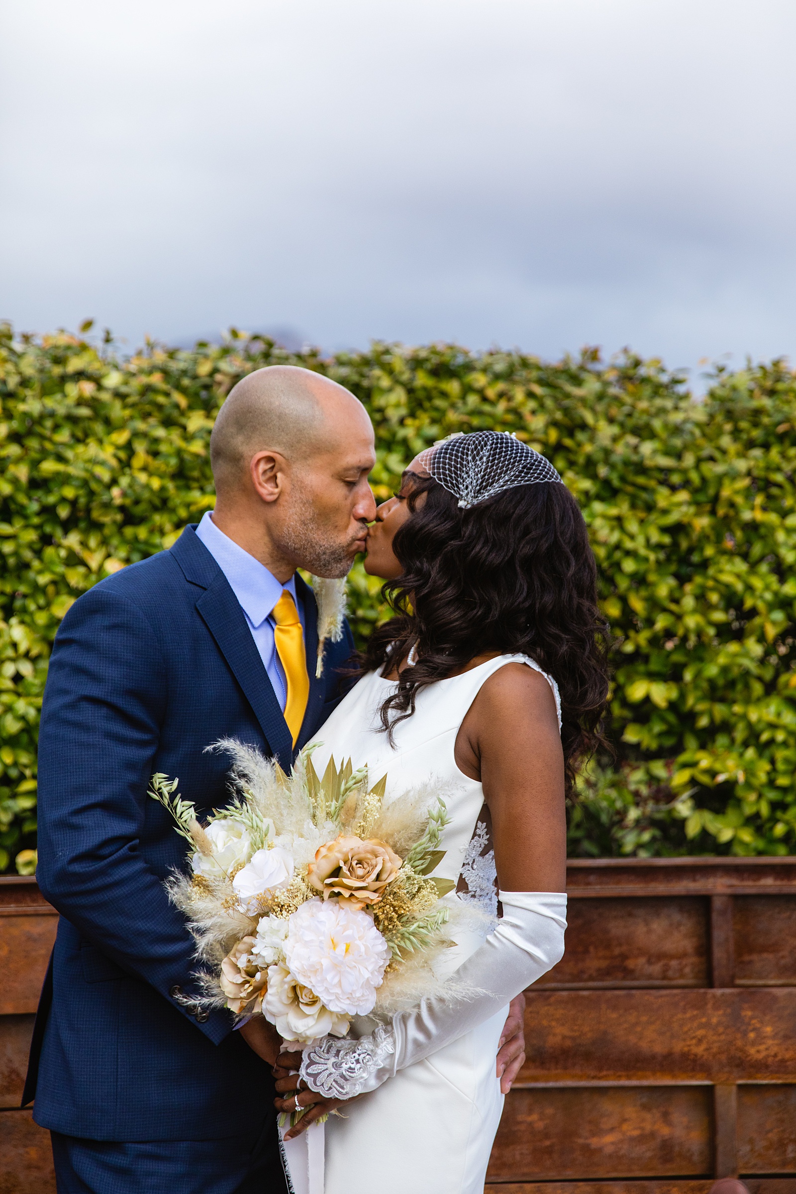 Newlyweds share a kiss during their Agave of Sedona wedding by Sedona wedding photographer PMA Photography.