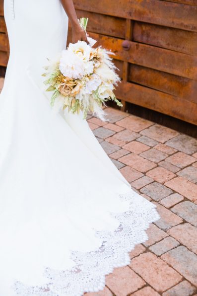 Bride's classic white and romantic wedding dress with dried floral boho bouquet for her Agave of Sedona wedding by PMA Photography.