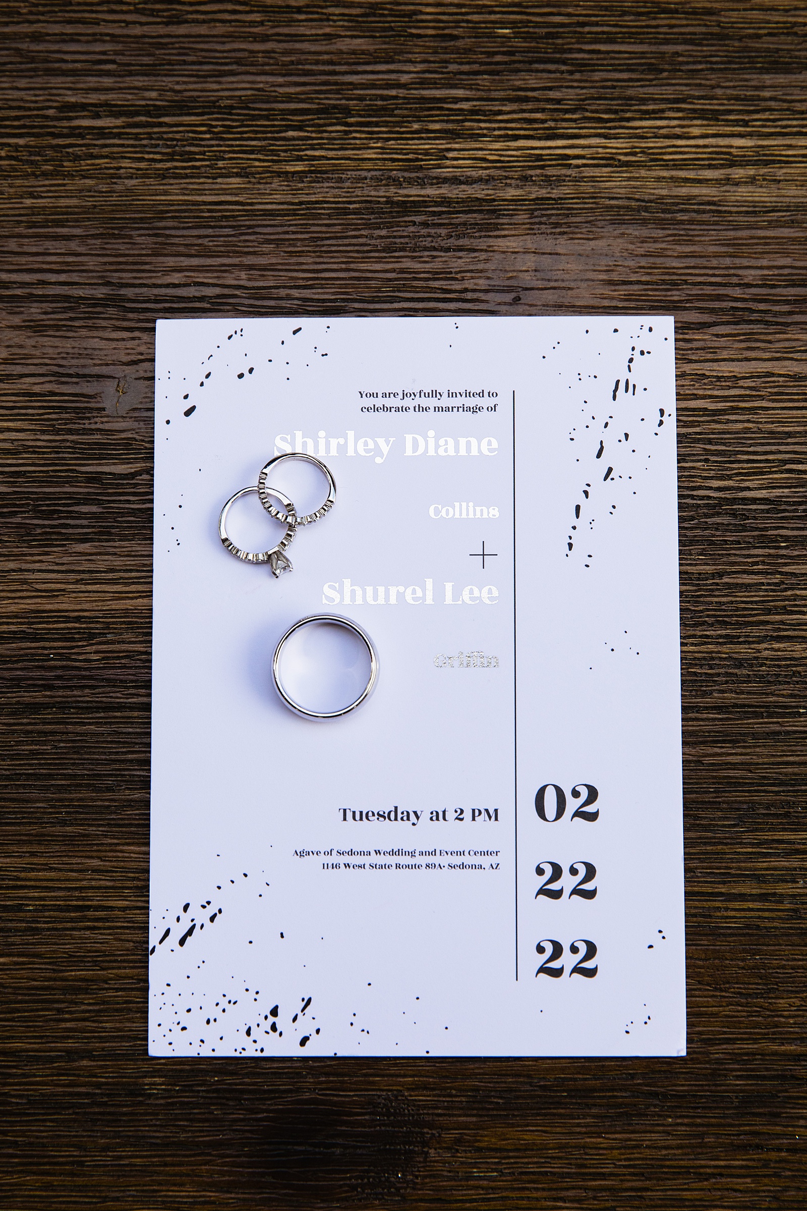 Couple's wedding rings on top of their simple modern wedding invitations by Arizona wedding photographer PMA Photography.