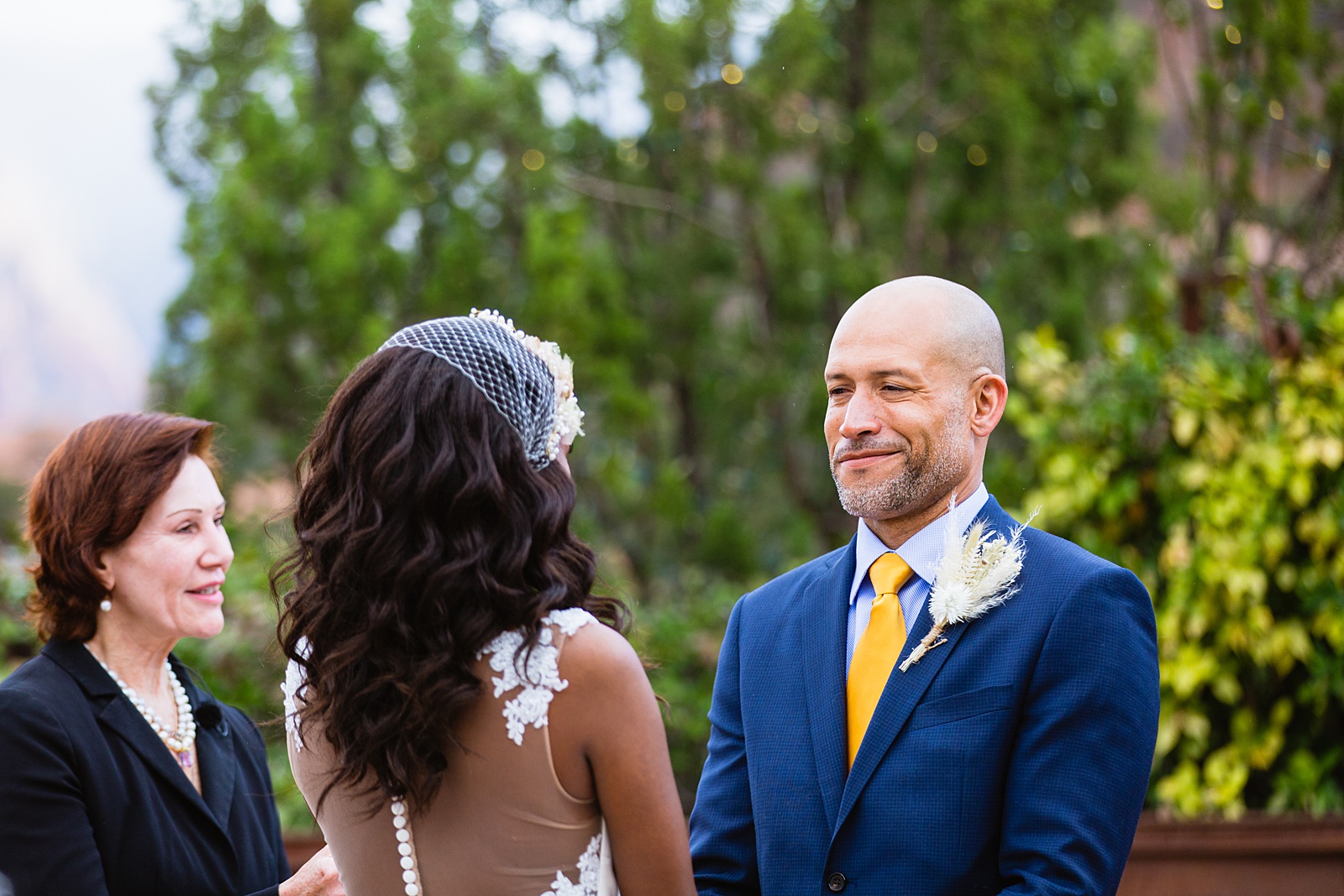 Groom looking at his bride during their wedding ceremony at Agave of Sedona by Sedona wedding photographer PMA Photography.