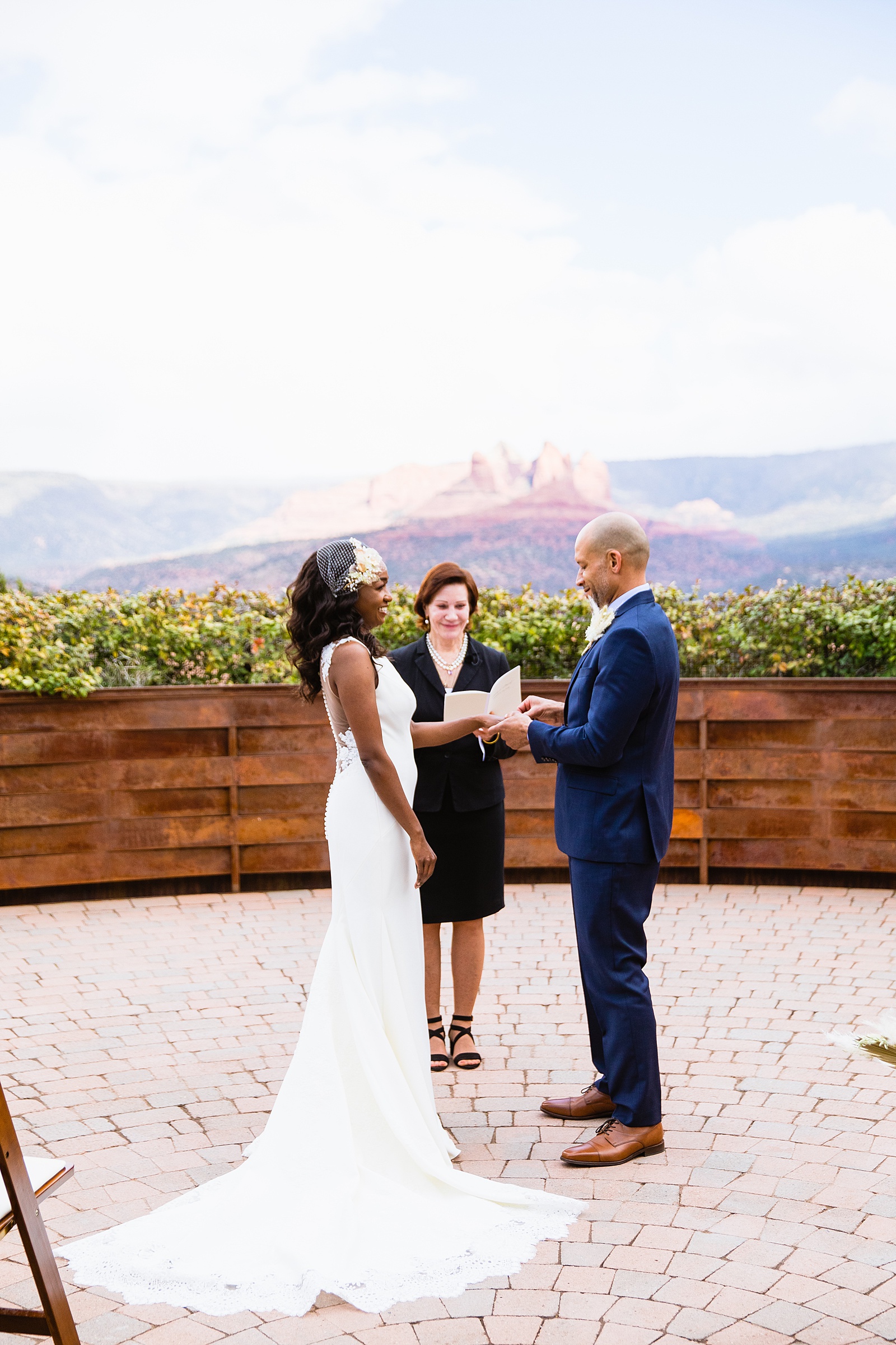 Bride and Groom exchange rings during their wedding ceremony at Agave of Sedona by Arizona wedding photographer PMA Photography.