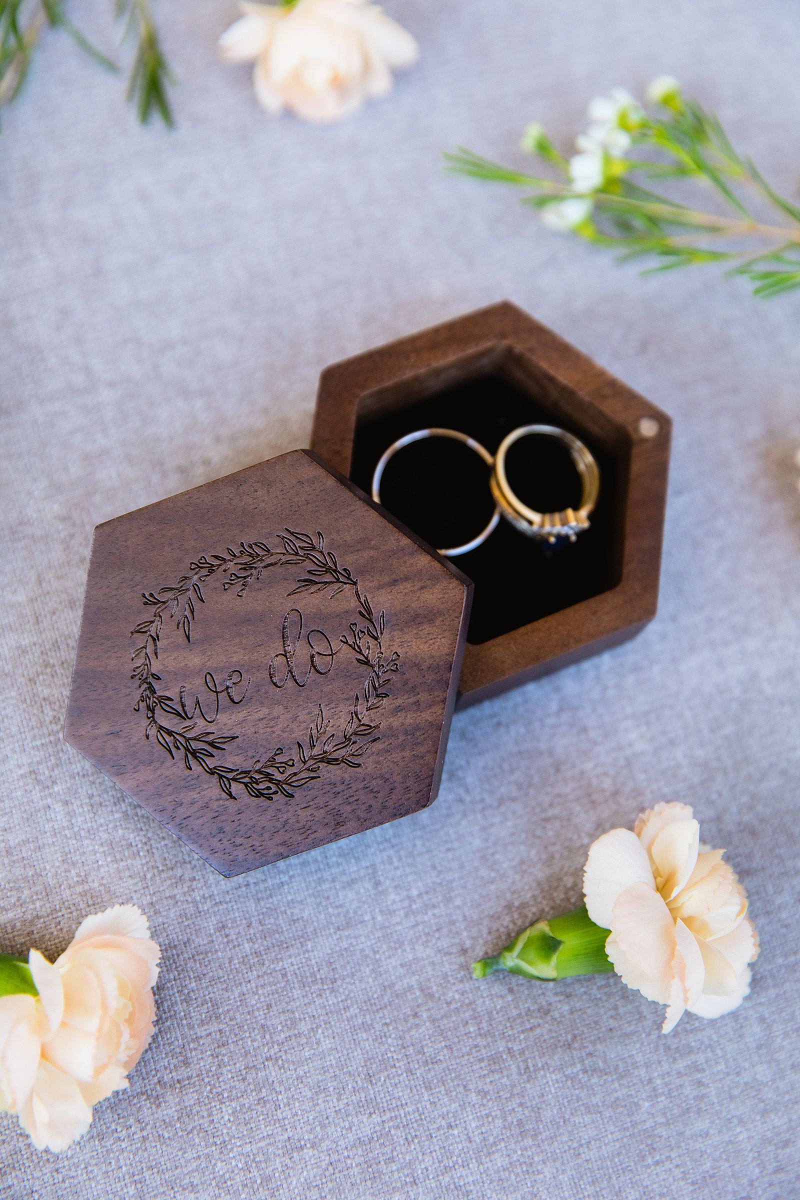 Rustic garden hexagon ring box with floral and "we do" engraved by Arizona wedding photographer PMA Photography.