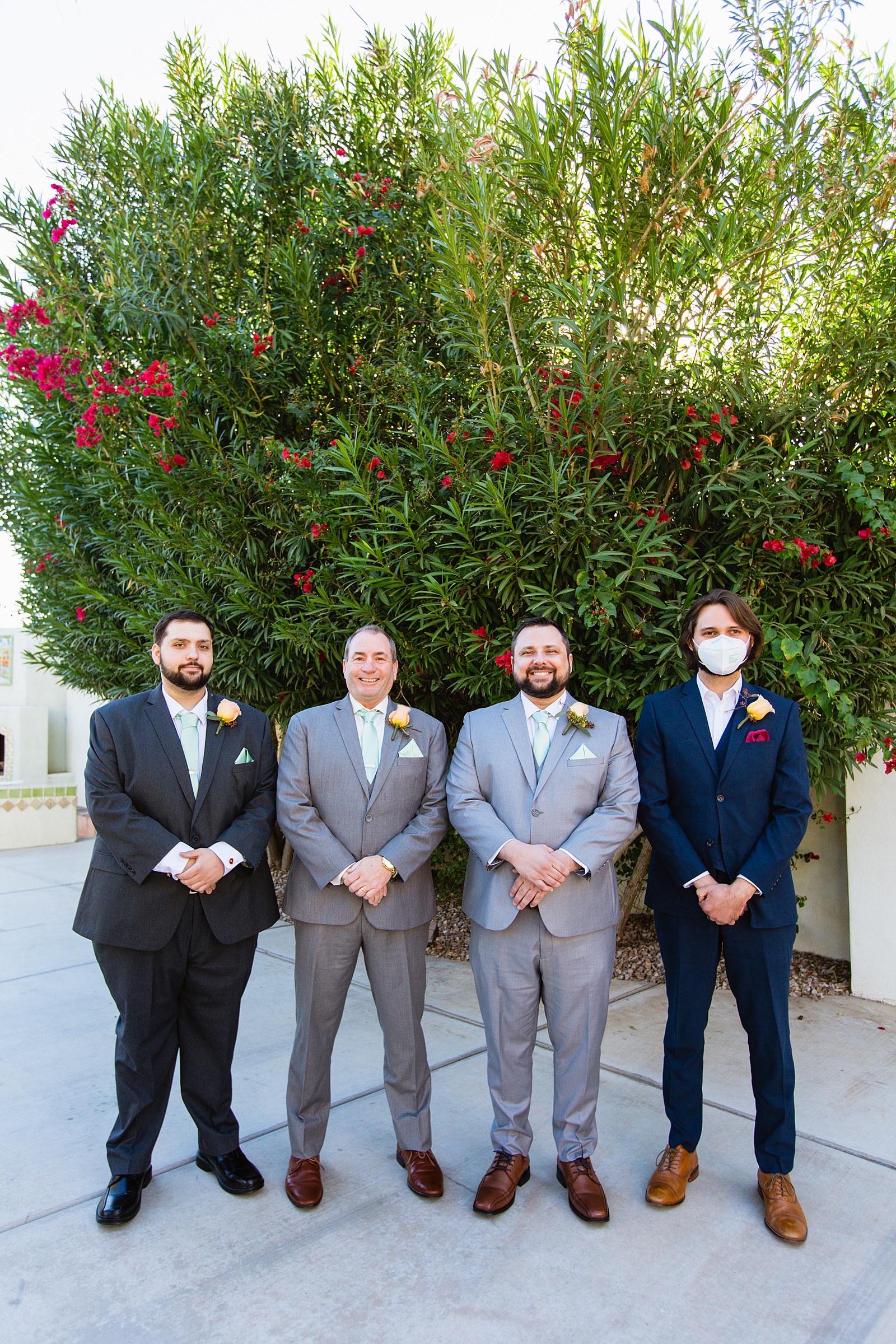 Groom and groomsmen together at a Bella Rose Estate wedding by Arizona wedding photographer PMA Photography.