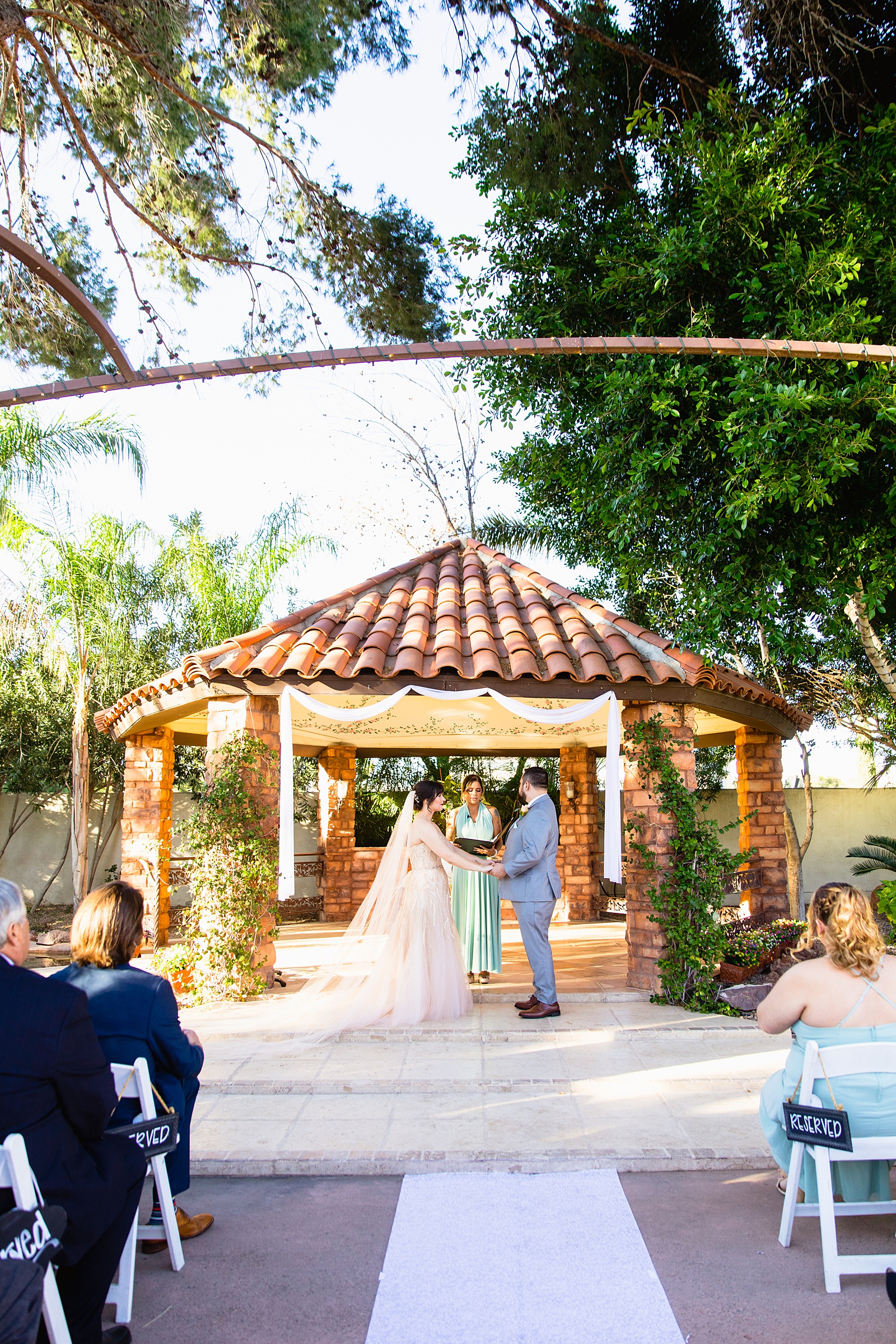 Wedding ceremony at Bella Rose Estate by Phoenix wedding photographer PMA Photography.