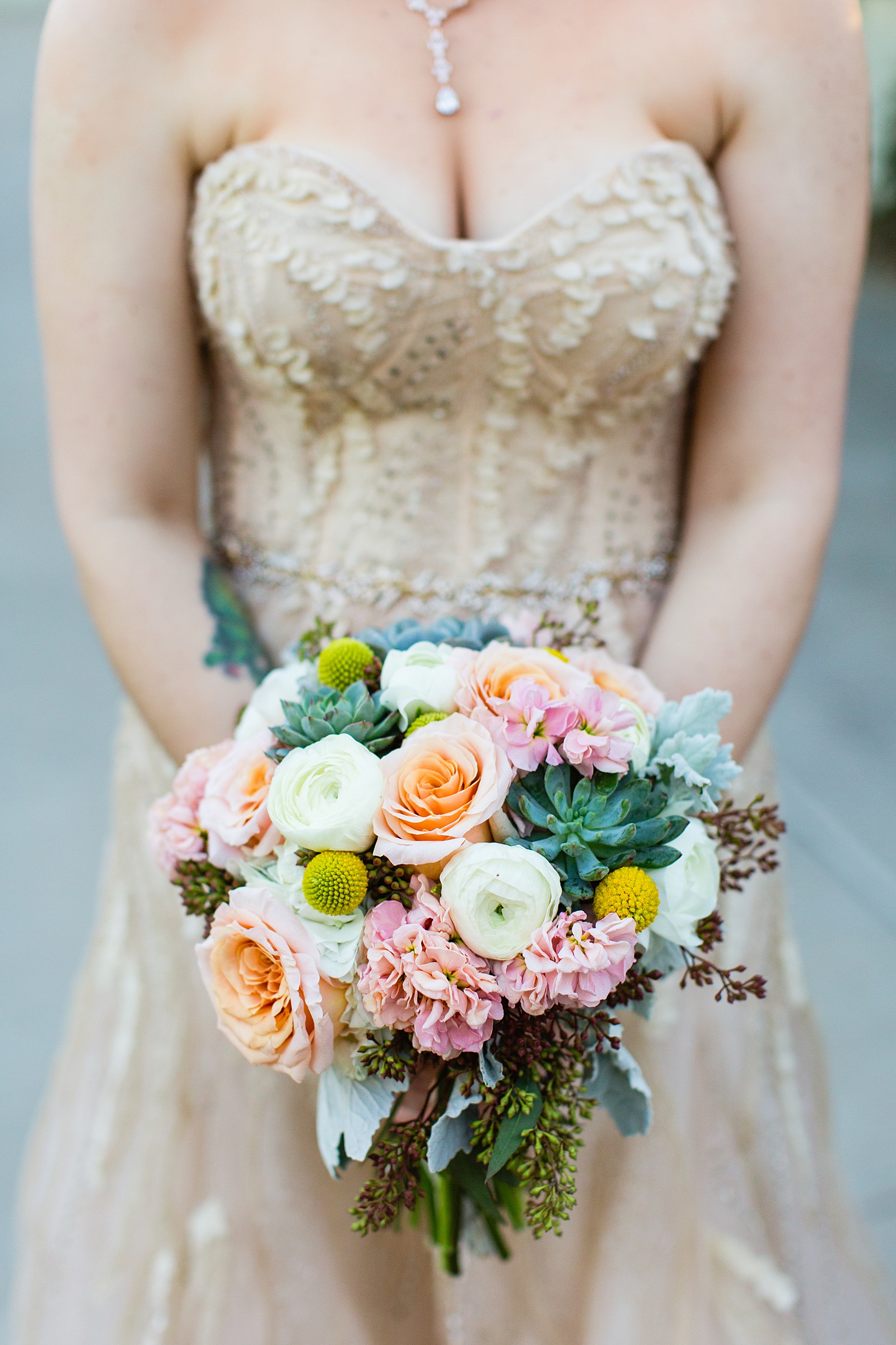 Bride's colorful garden bouquet with succulents and roses by PMA Photography.