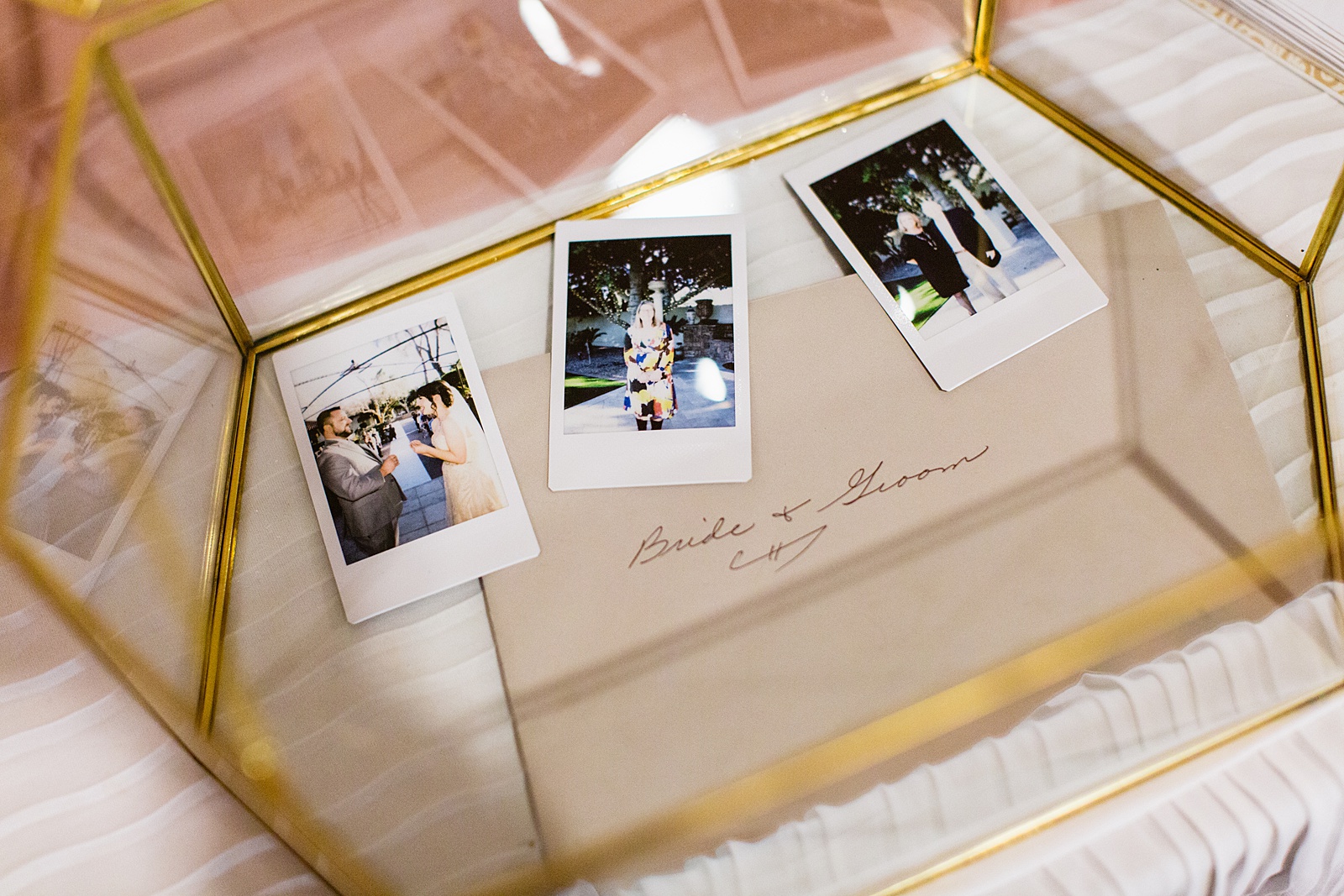 Polaroid pictures from a wedding inside of the card box by PMA Photography.