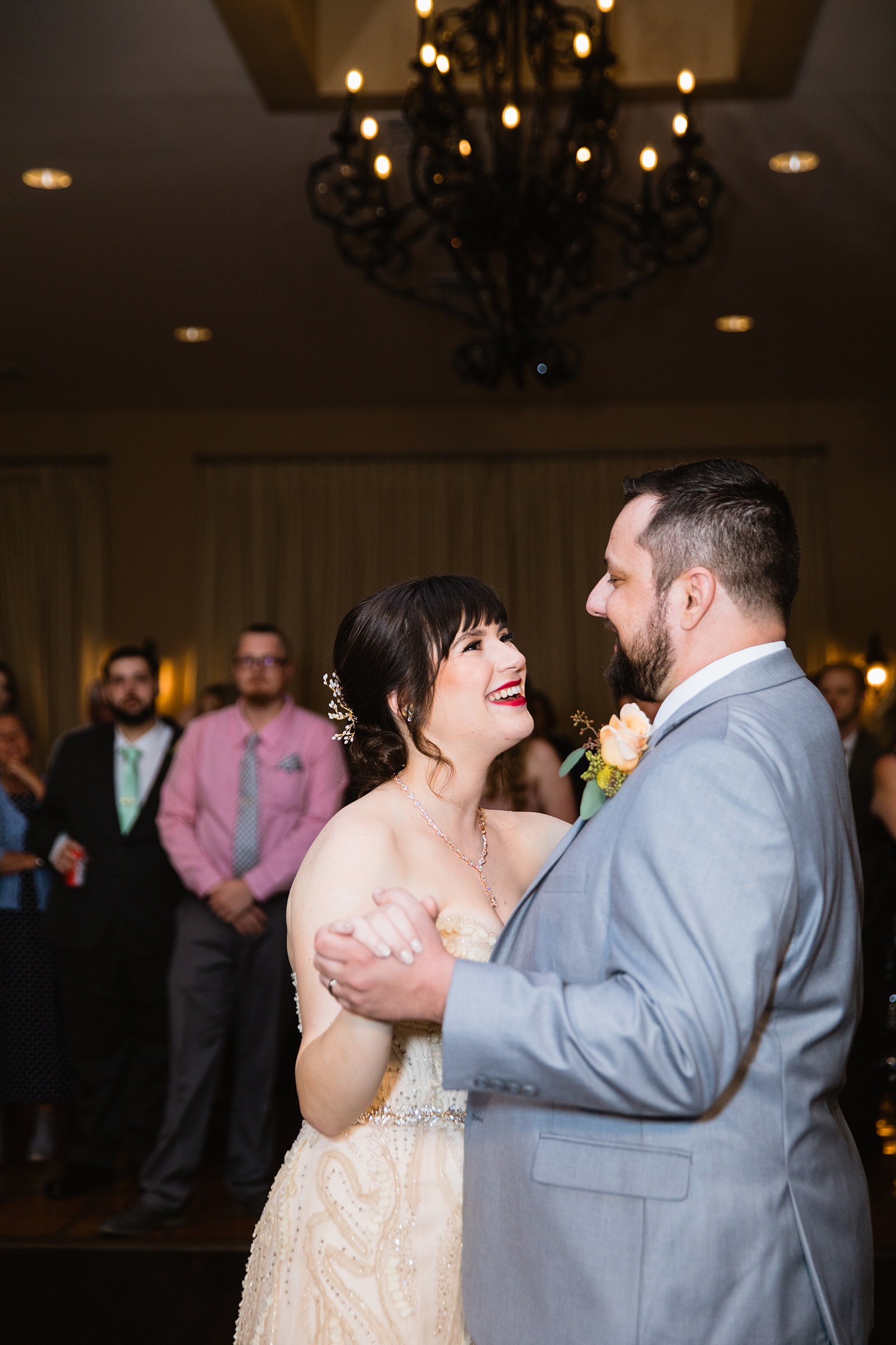 Bride and Groom sharing first dance at their Bella Rose Estate wedding reception by Arizona wedding photographer PMA Photography.