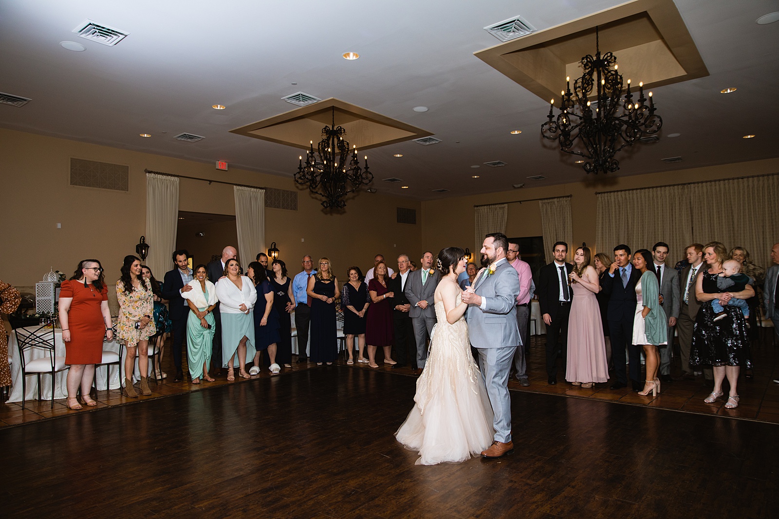 Bride and Groom sharing first dance at their Bella Rose Estate wedding reception by Arizona wedding photographer PMA Photography.