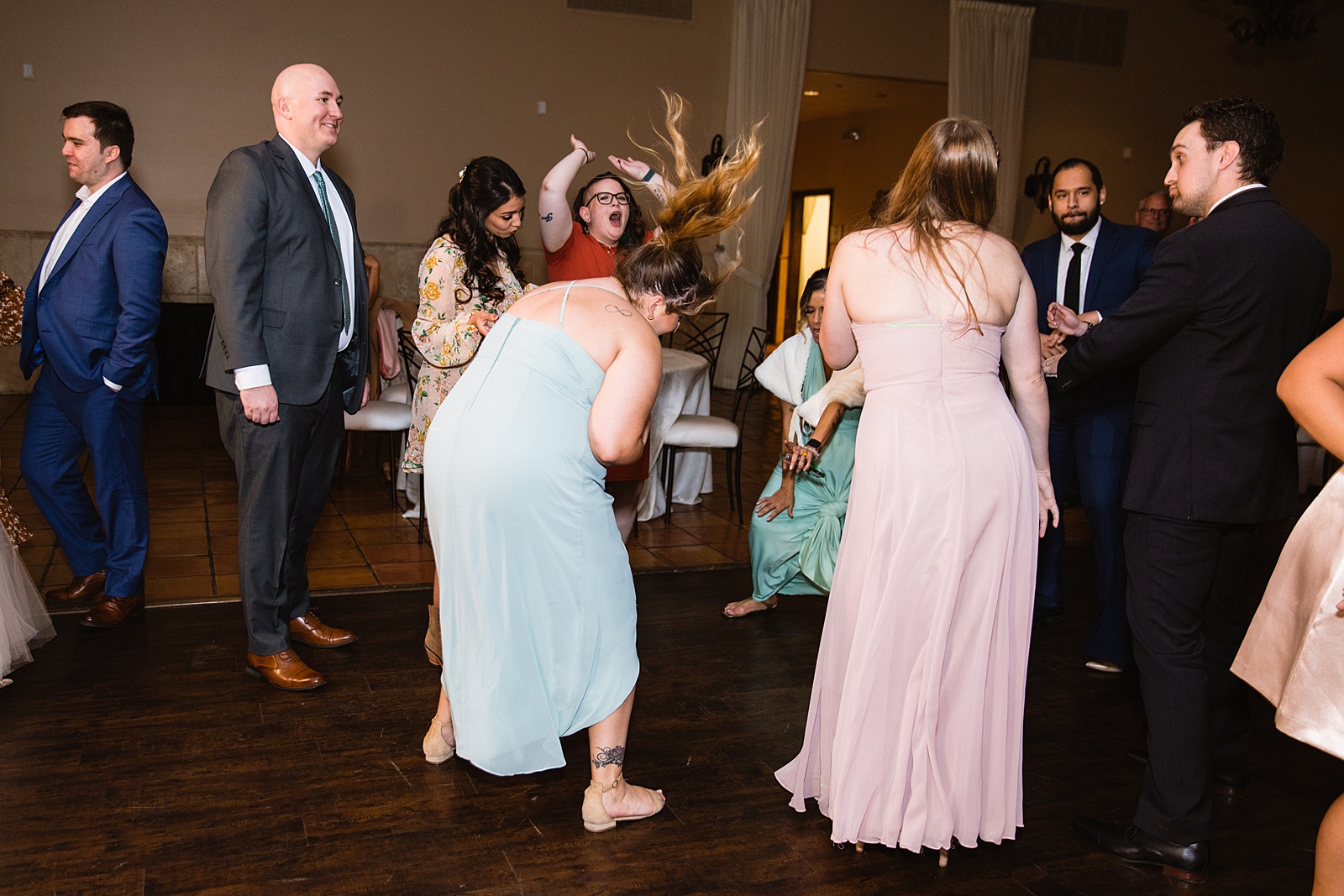 Guests dancing together at Bella Rose Estate wedding reception by Chandler wedding photographer PMA Photography