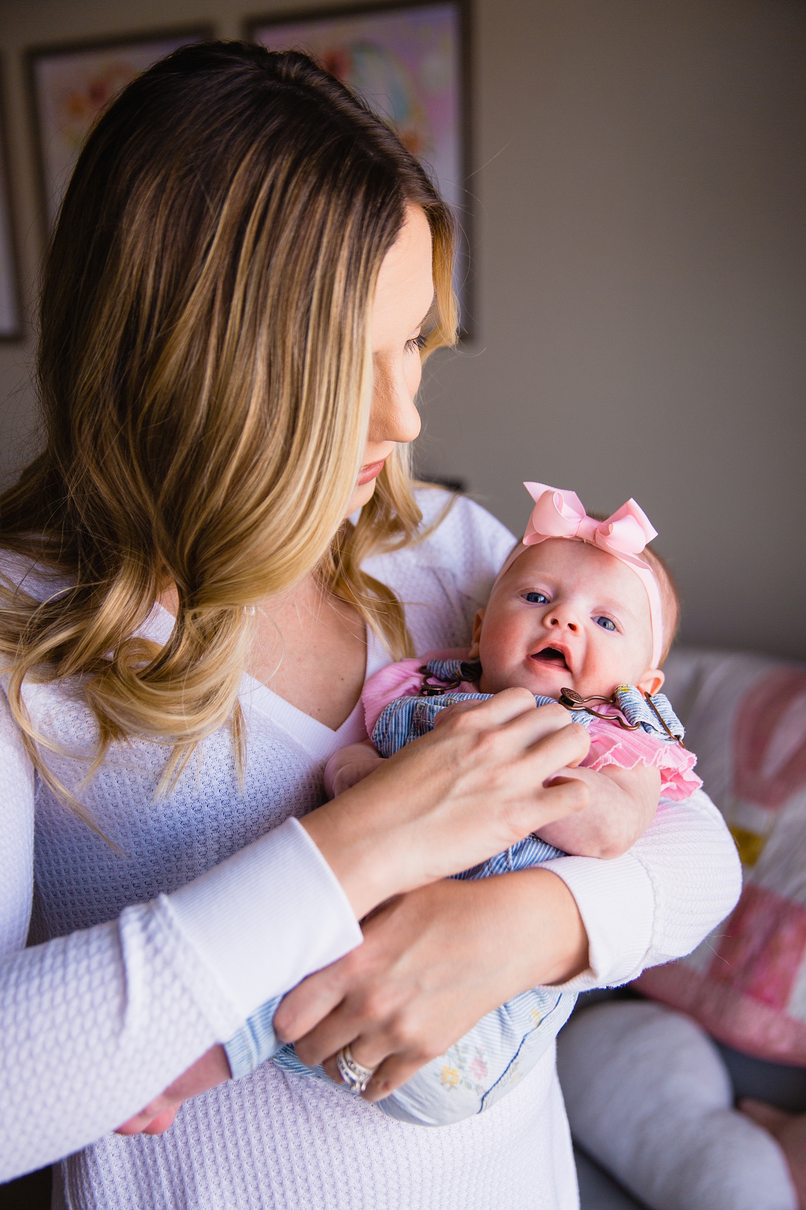 Mother and daughter together during their in home newborn family session by Arizona family photographer PMA Photography.