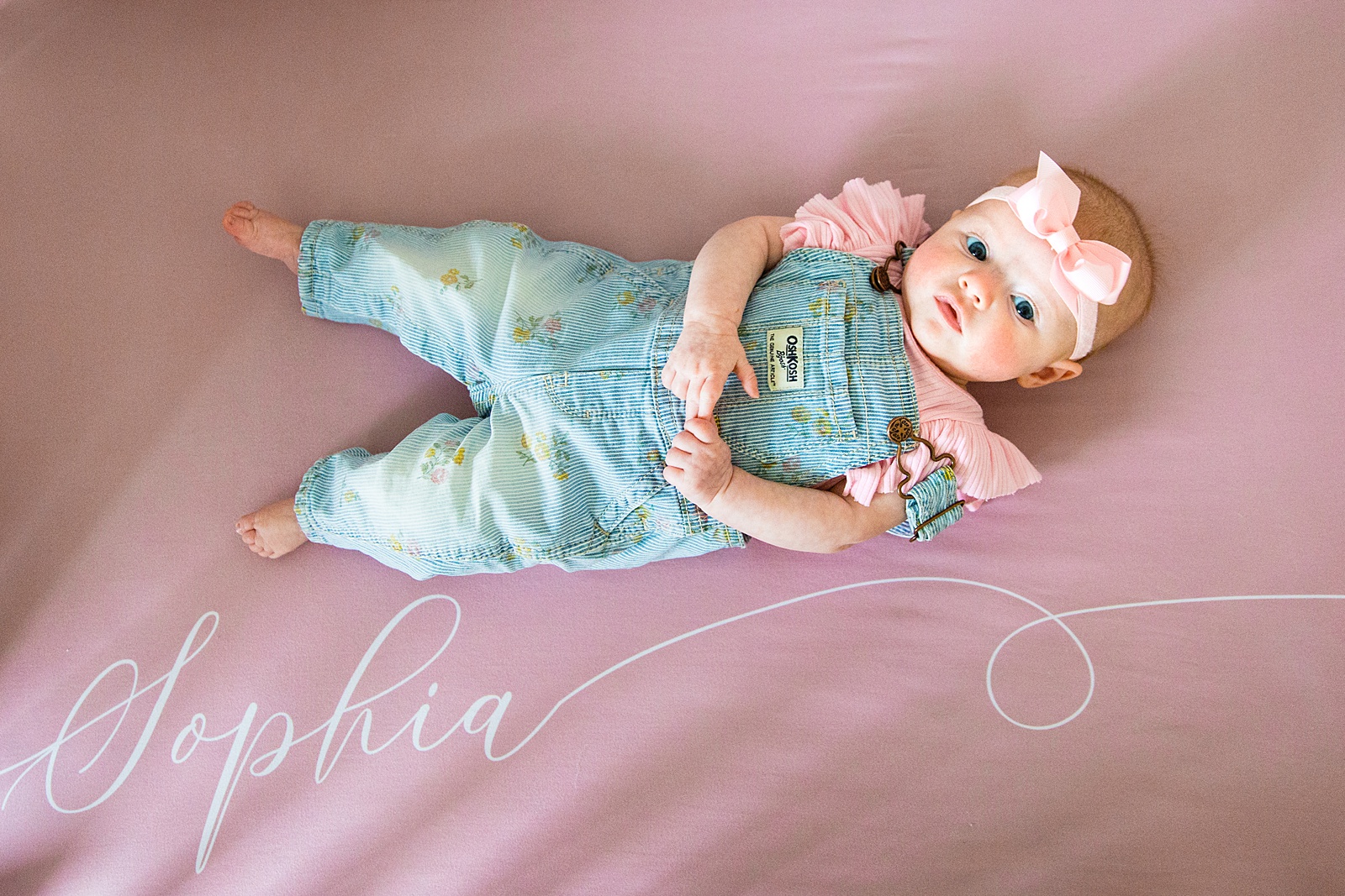Portrait of a baby in her crib during an at home family session by PMA Photography.