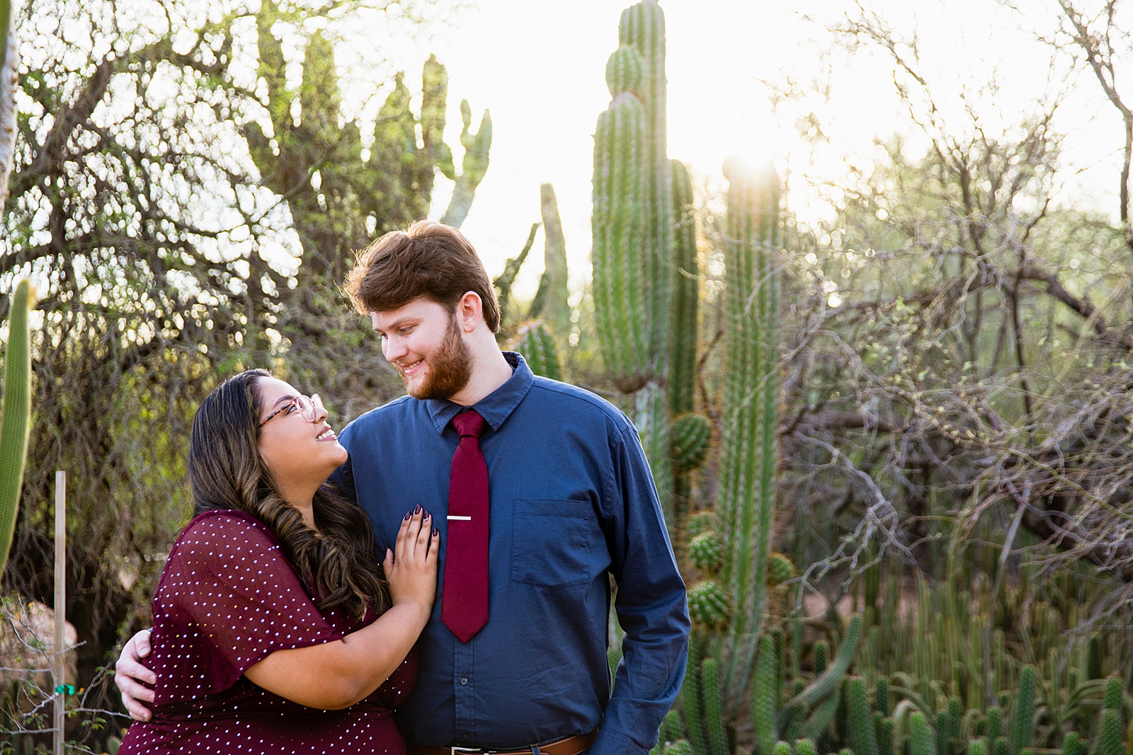 Couple look at each other during their Desert Botanical Gardens engagement session by Phoenix wedding photographer PMA Photography.