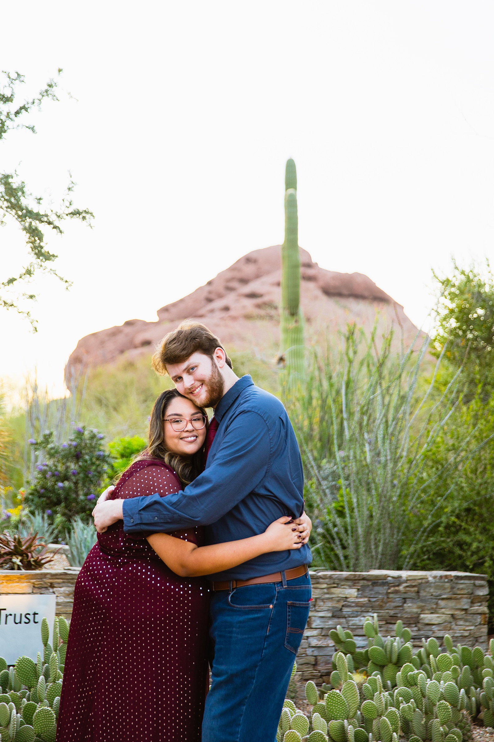Couple pose for their Desert Botanical Gardens engagement session by Phoenix wedding photographer PMA Photography.