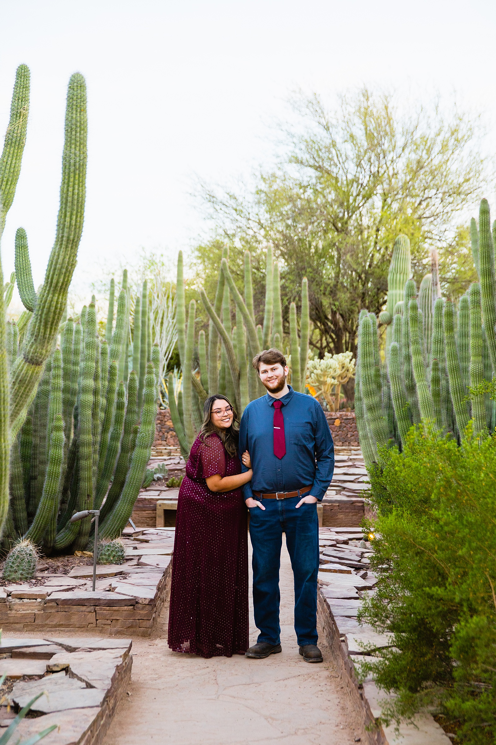 Couple pose during their Phoenix engagement session by Arizona wedding photographer PMA Photography.