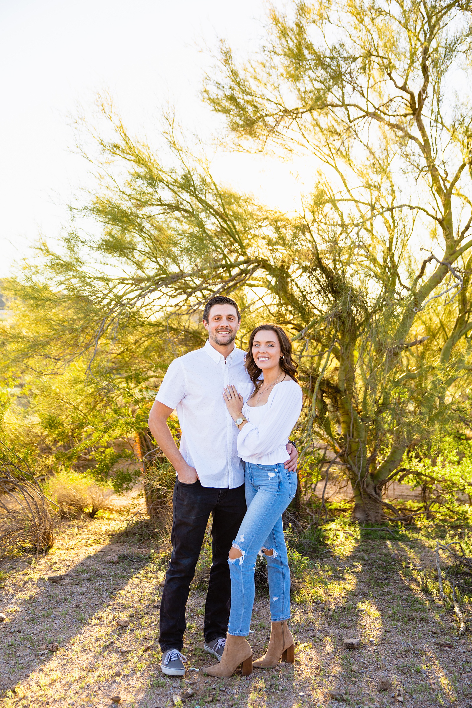 Couple pose for their desert engagement session by Phoenix wedding photographer PMA Photography.