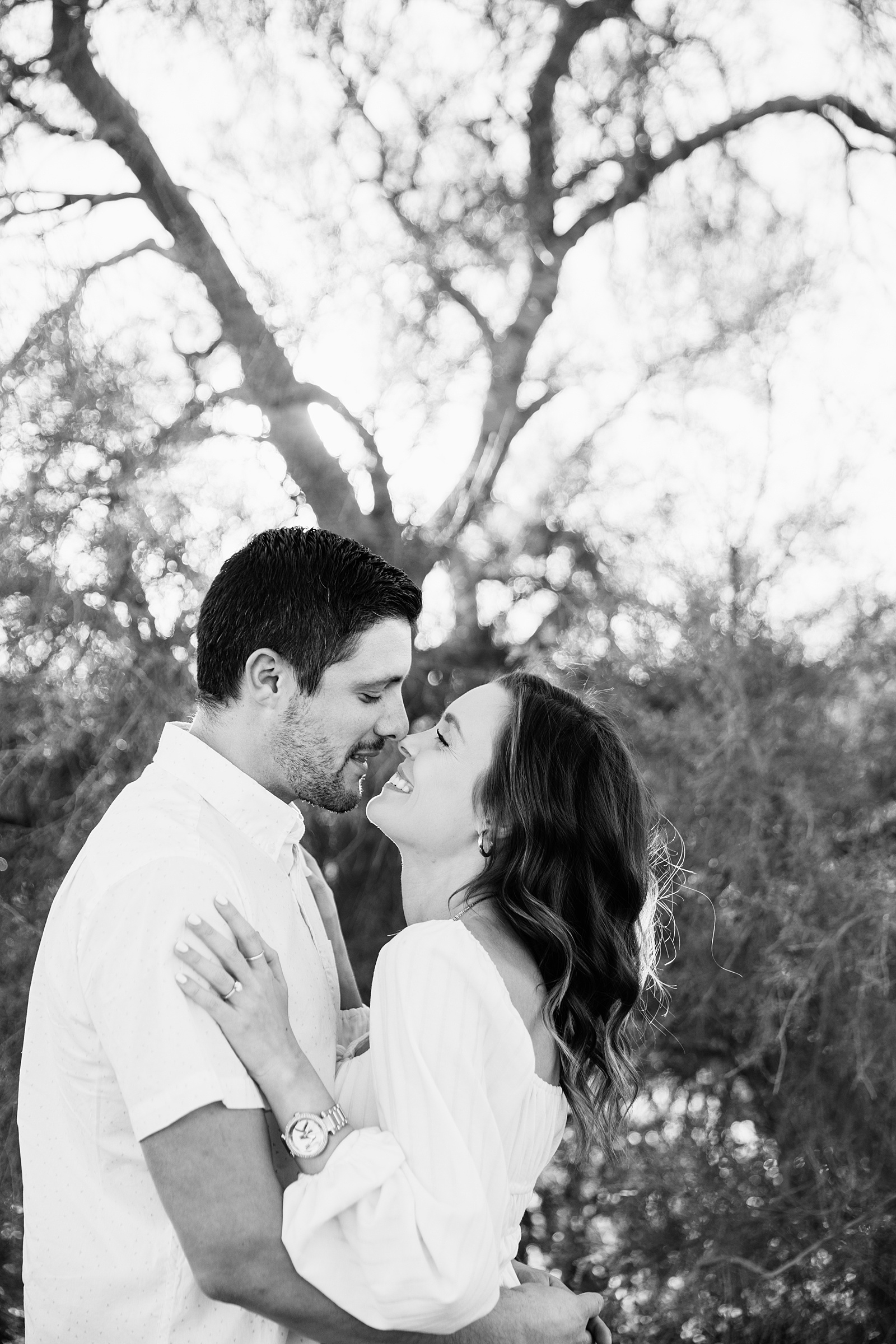 Couple share an intimate moment during their desert engagement session by Phoenix engagement photographer PMA Photography.
