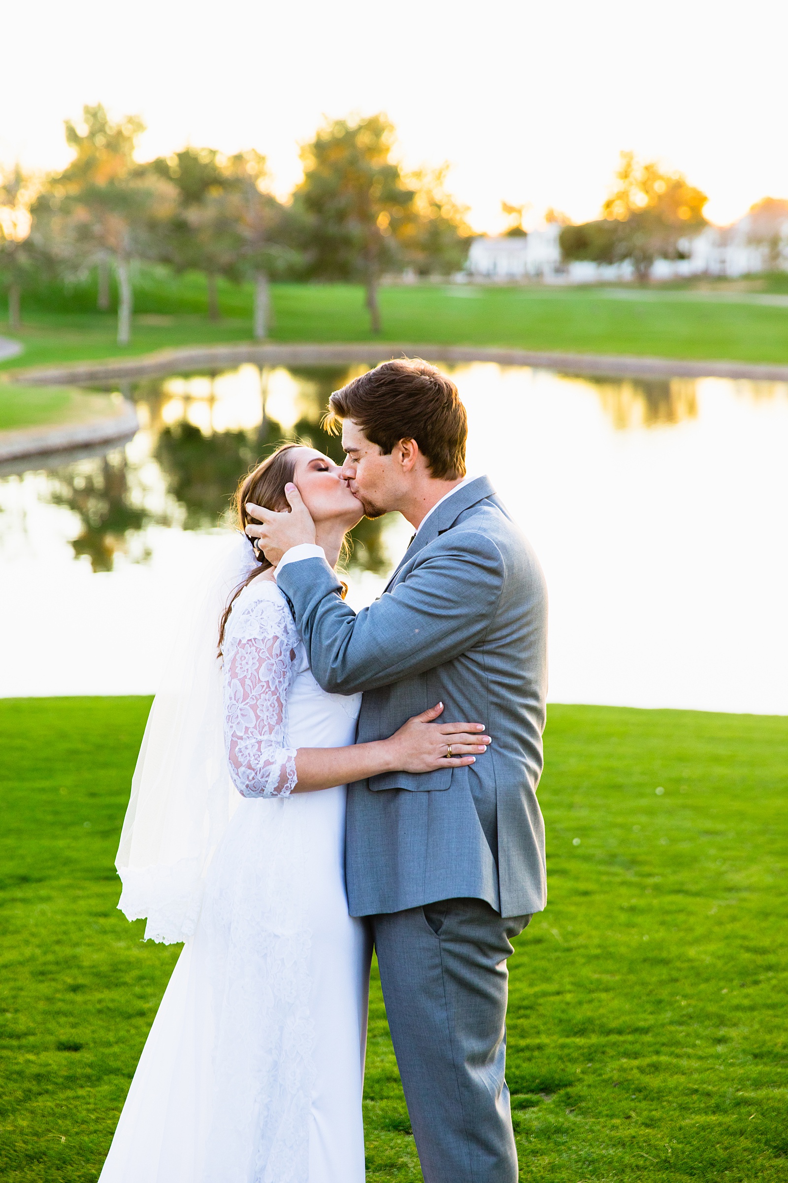 Newlyweds share a kiss during their Ocotillo Oasis wedding by Arizona wedding photographer PMA Photography.