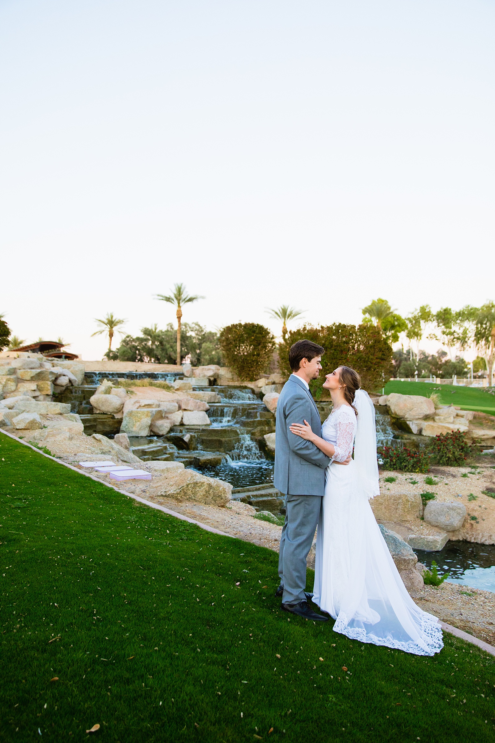 Newlyweds pose for their Ocotillo Oasis wedding by Phoenix wedding photographer PMA Photography.