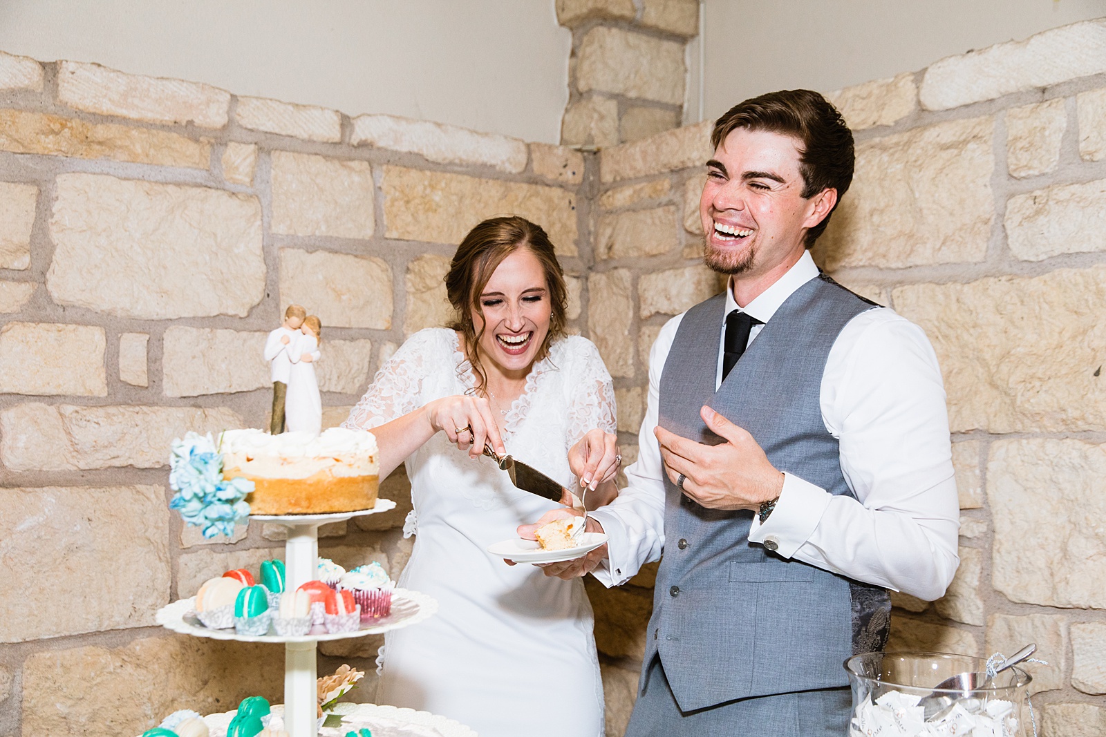 Newlyweds cutting their wedding cake at their Ocotillo Oasis wedding reception by Arizona wedding photographer PMA Photography.
