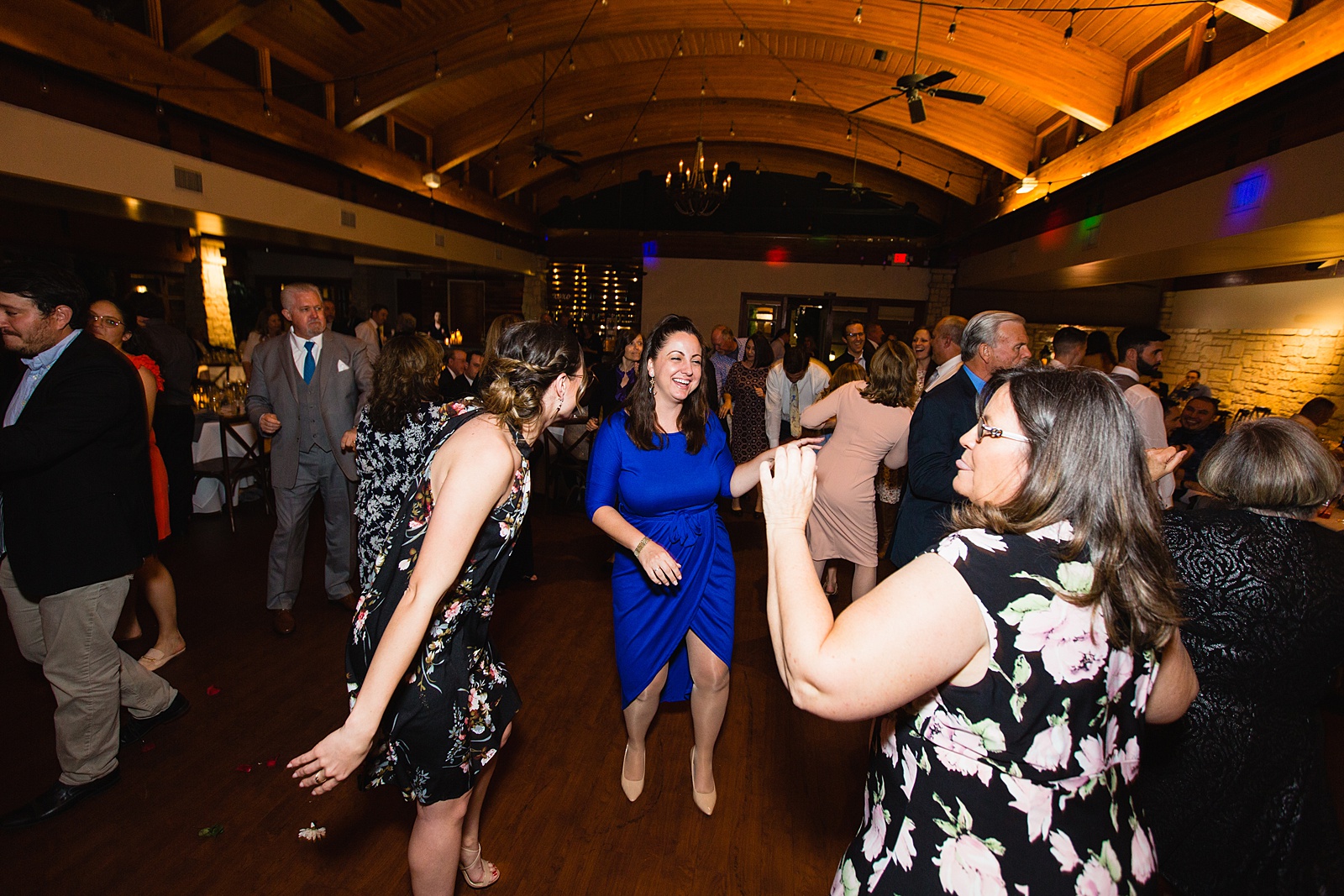 Guests dancing together at Ocotillo Oasis wedding reception by Phoenix wedding photographer PMA Photography