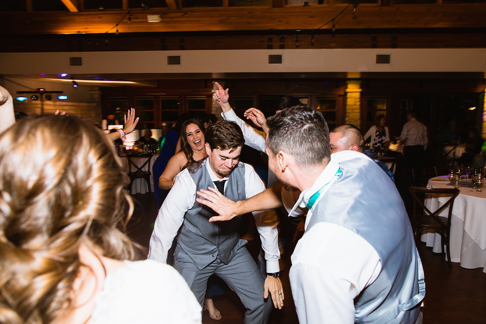 Groom dancing with guests at Ocotillo Oasis wedding reception by Phoenix wedding photographer PMA Photography
