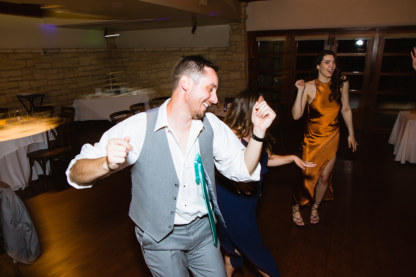 Guests dancing together at Ocotillo Oasis wedding reception by Phoenix wedding photographer PMA Photography