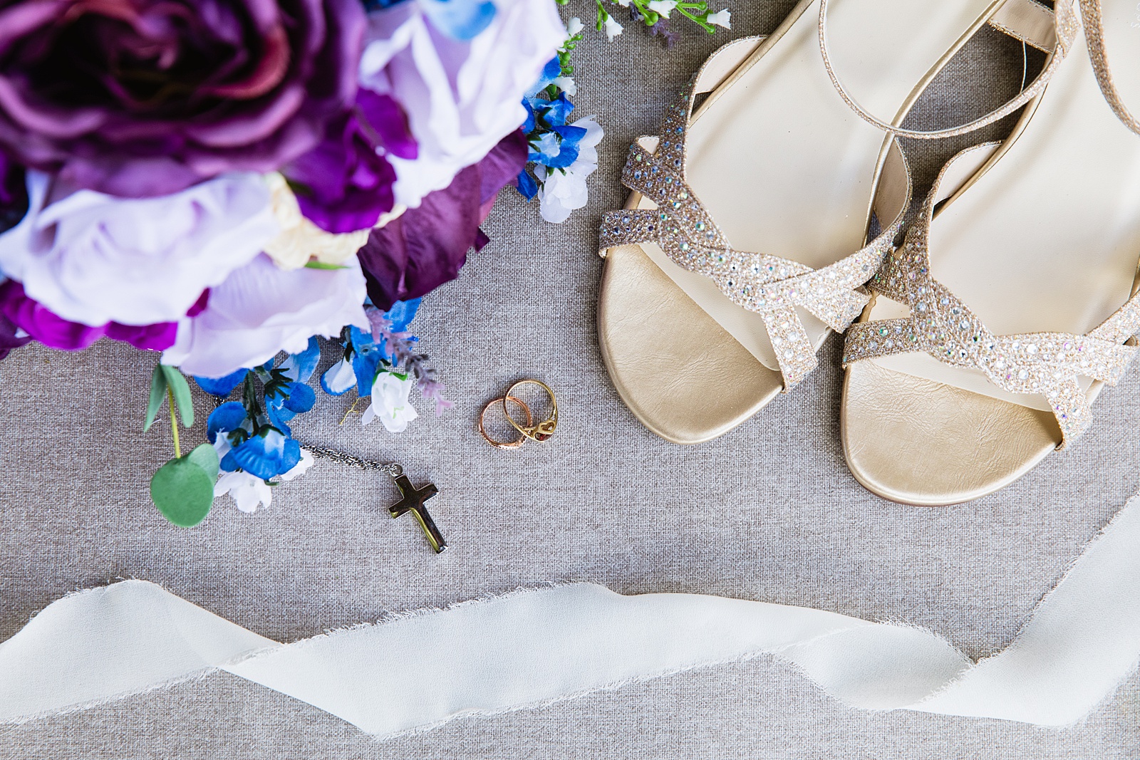 Brides wedding day details of shoes, rings, purple bouquet, and necklace by PMA Photography.