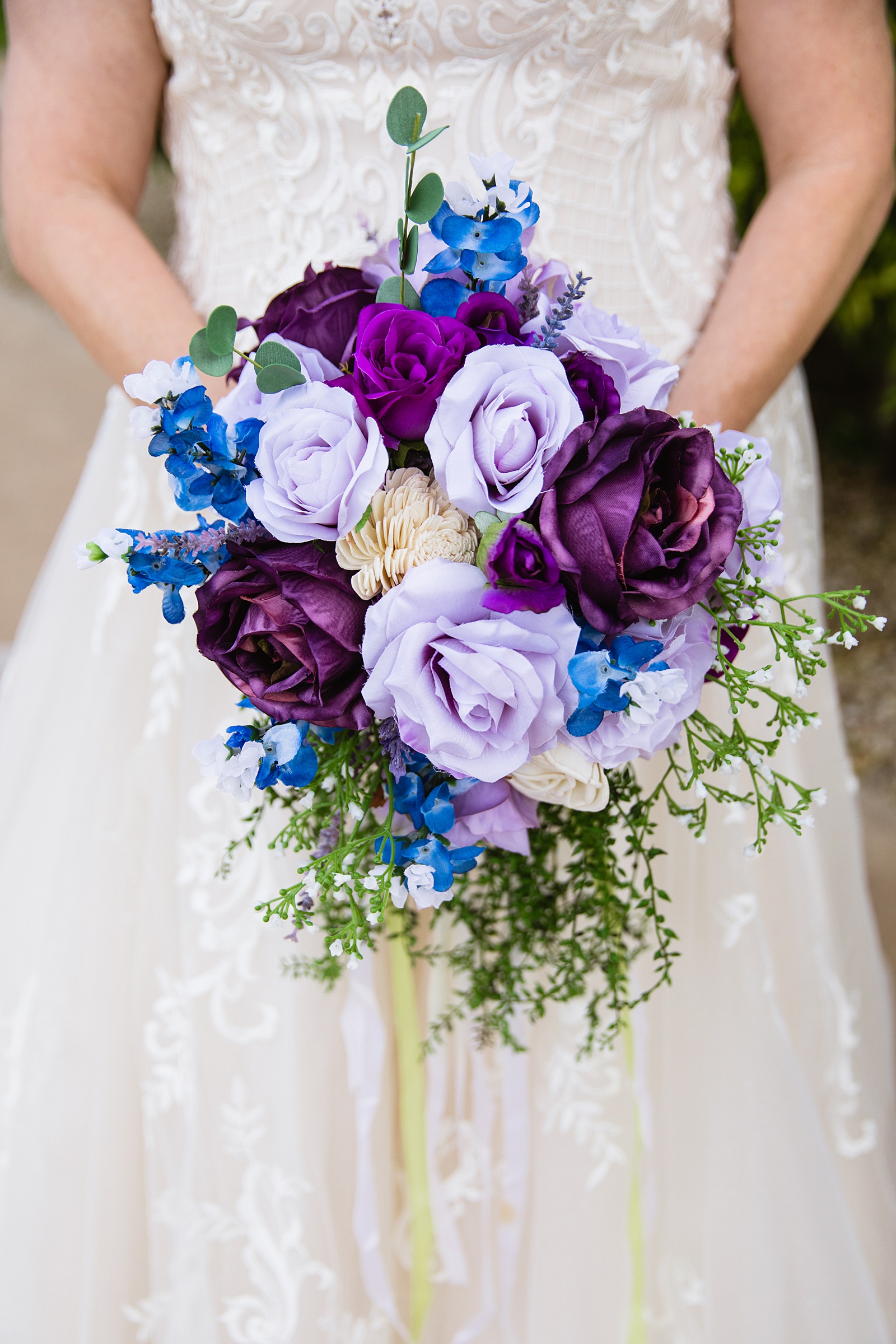 Bride's purple faux flower bouquet by PMA Photography.