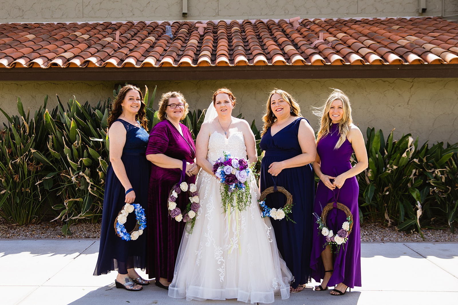 Bride and bridesmaids together at a Sun Valley Church wedding by Arizona wedding photographer PMA Photography.