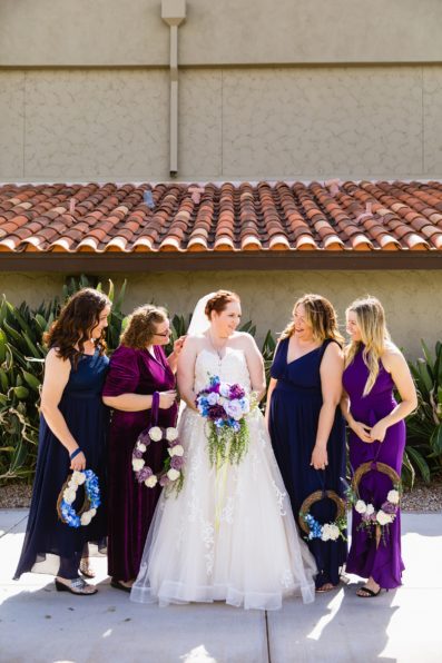 Bride and bridesmaids laughing together at Sun Valley Church wedding by Tempe wedding photographer PMA Photography.