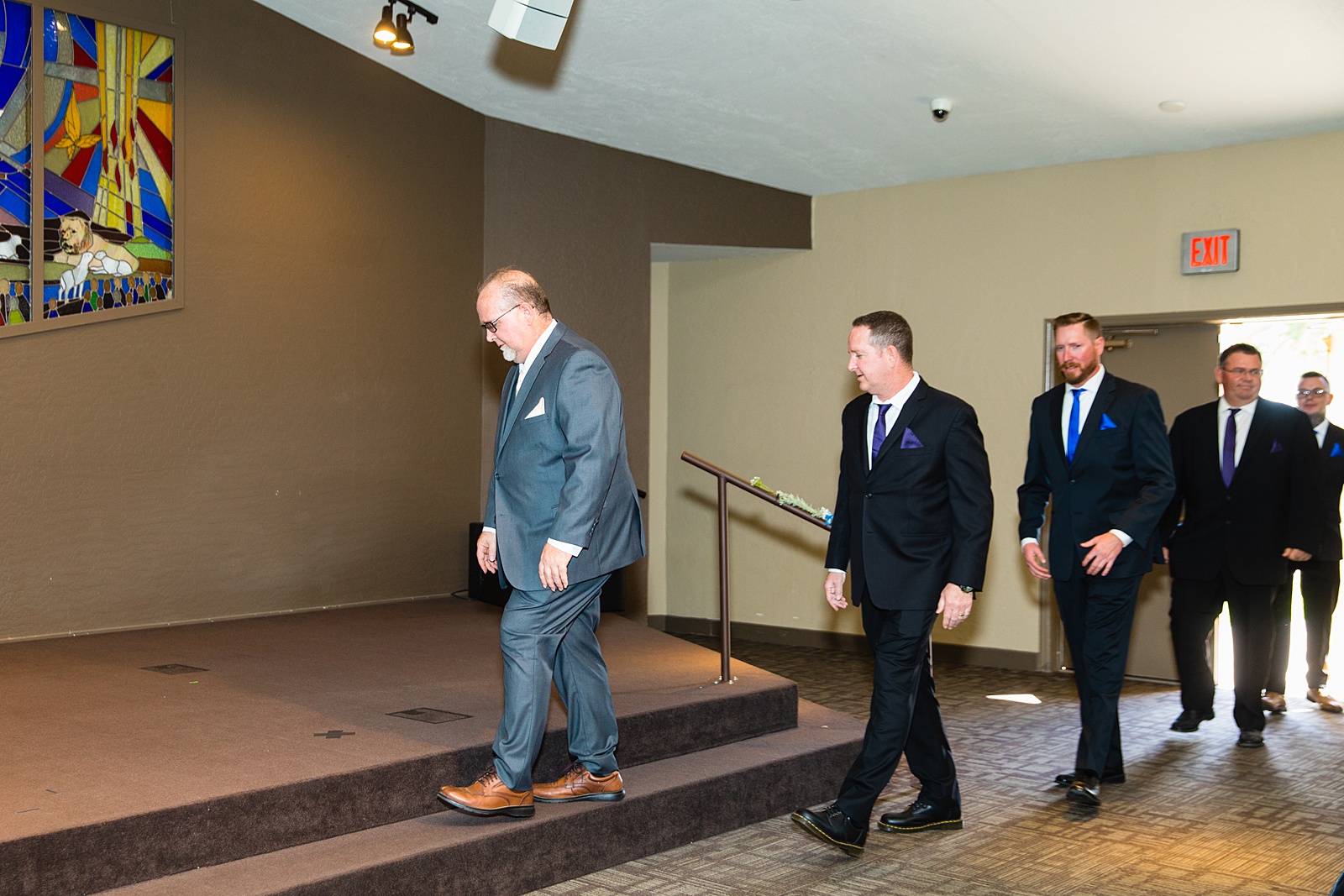 Groom walking down aisle during Sun Valley Church wedding ceremony by Phoenix wedding photographer PMA Photography.