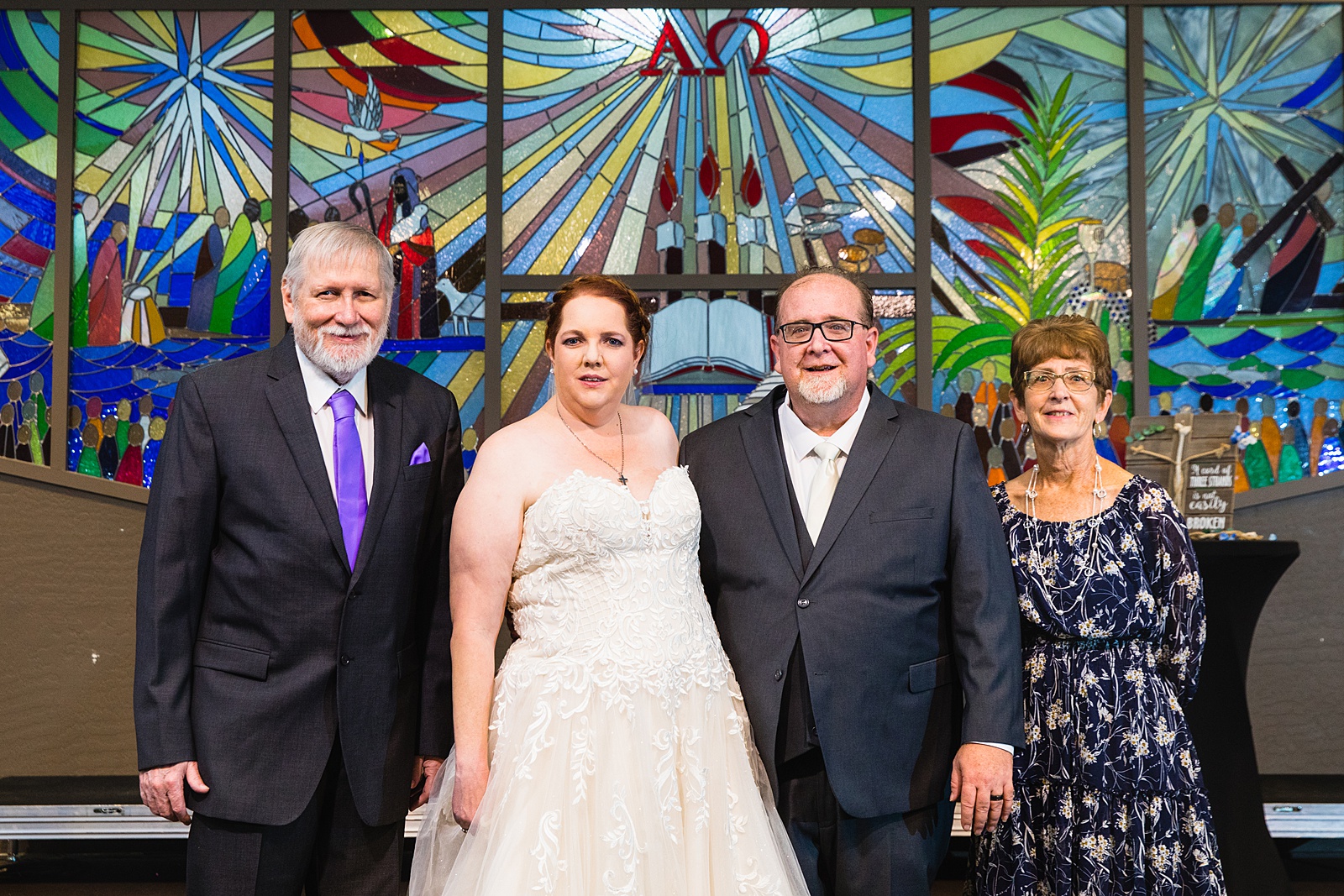 Bride and Groom pose with family during their Sun Valley Church wedding by Arizona wedding photographer PMA Photography.
