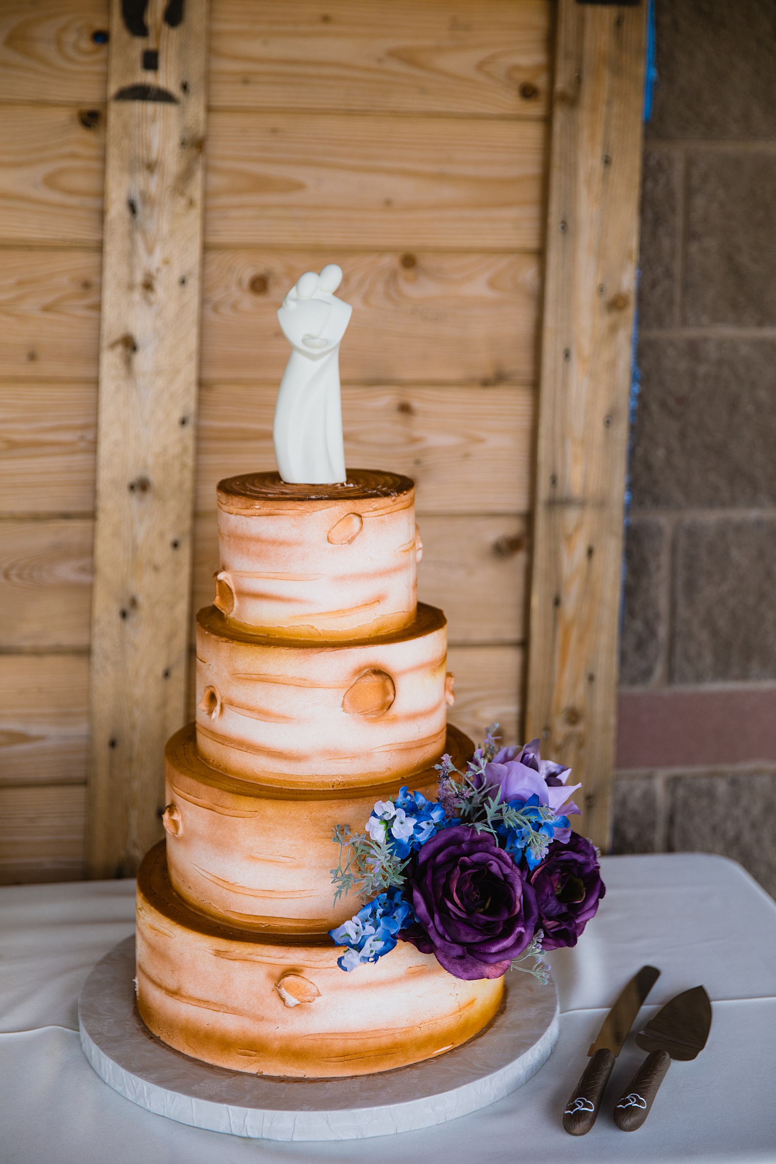 Rustic wood wedding cake at a 101 Polo Club reception by Arizona wedding photographer PMA Photography.