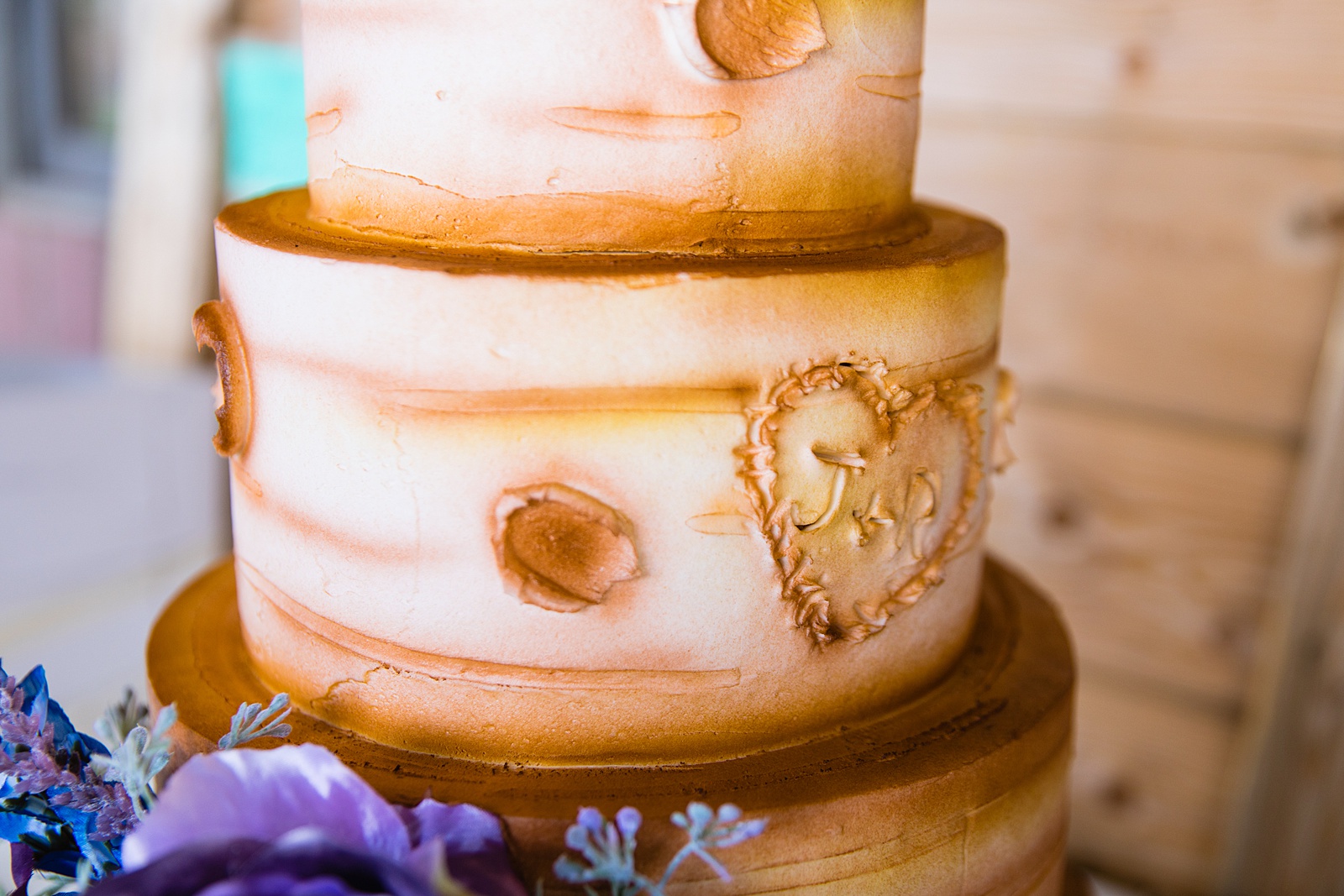 Rustic wood wedding cake at a 101 Polo Club reception by Arizona wedding photographer PMA Photography.