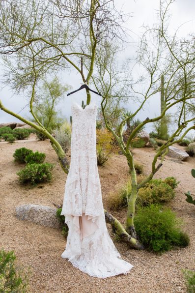 Brides romantic, lace wedding dress at her desert wedding at Troon North by Scottsdale wedding photographer PMA Photography.