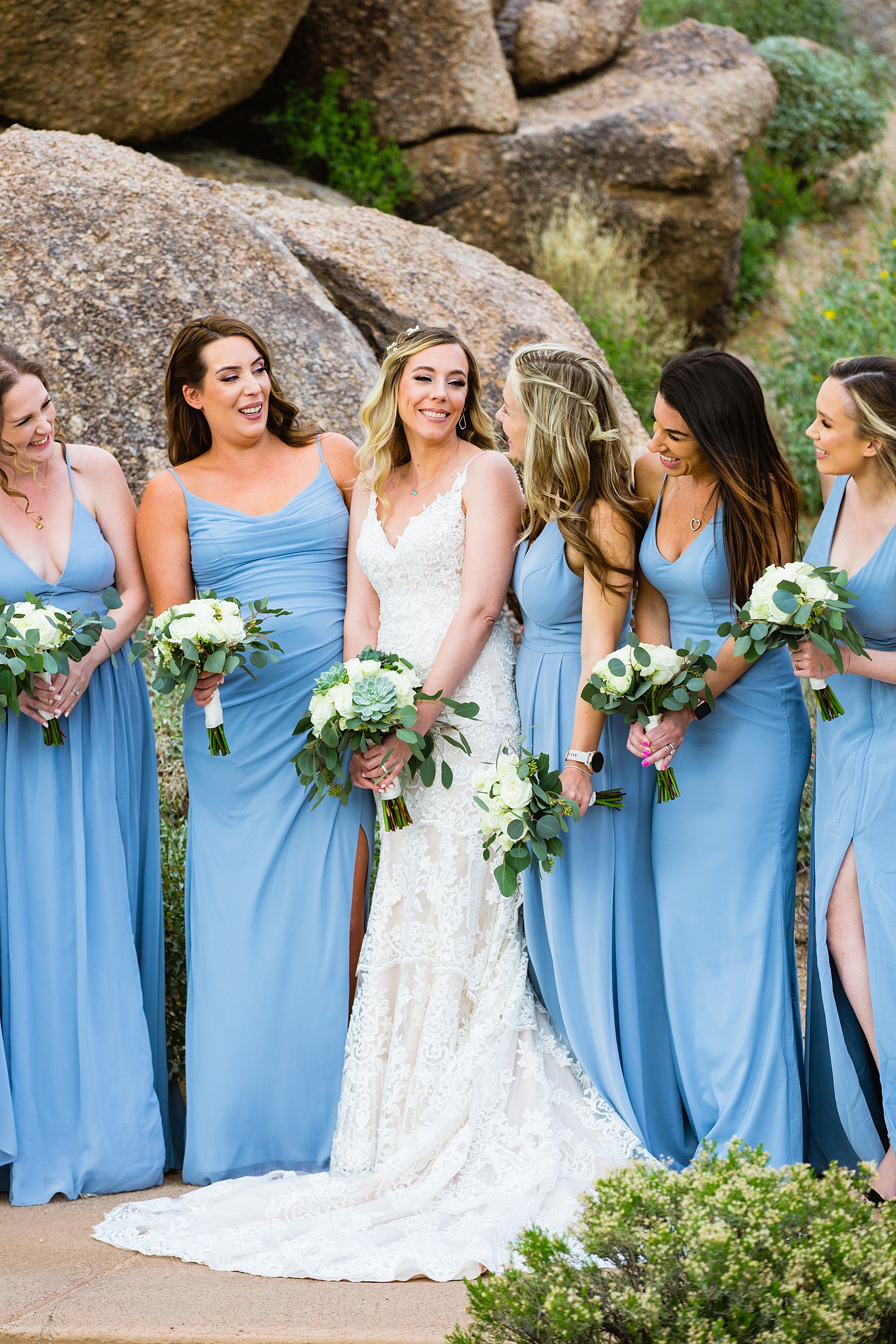 Bride and bridesmaids laughing together at Troon North wedding by Scottsdale wedding photographer PMA Photography.