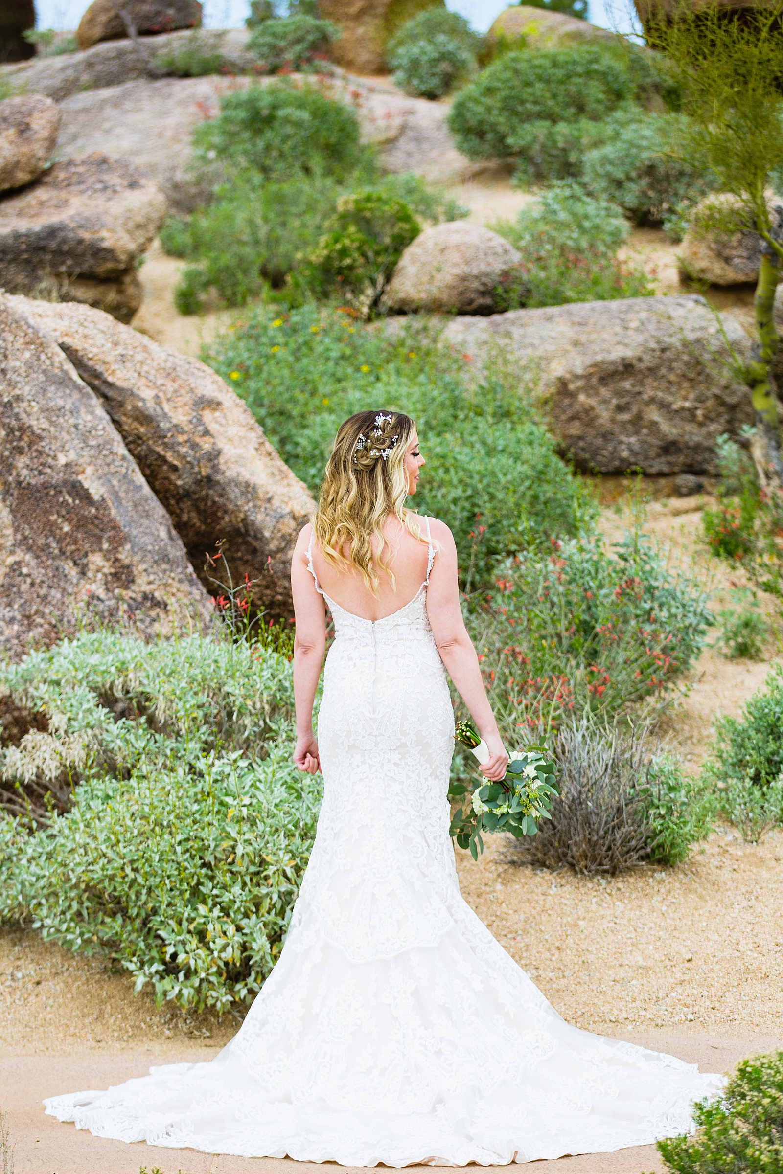 Brides romantic, lace wedding dress at her desert wedding at Troon North by Scottsdale wedding photographer PMA Photography.