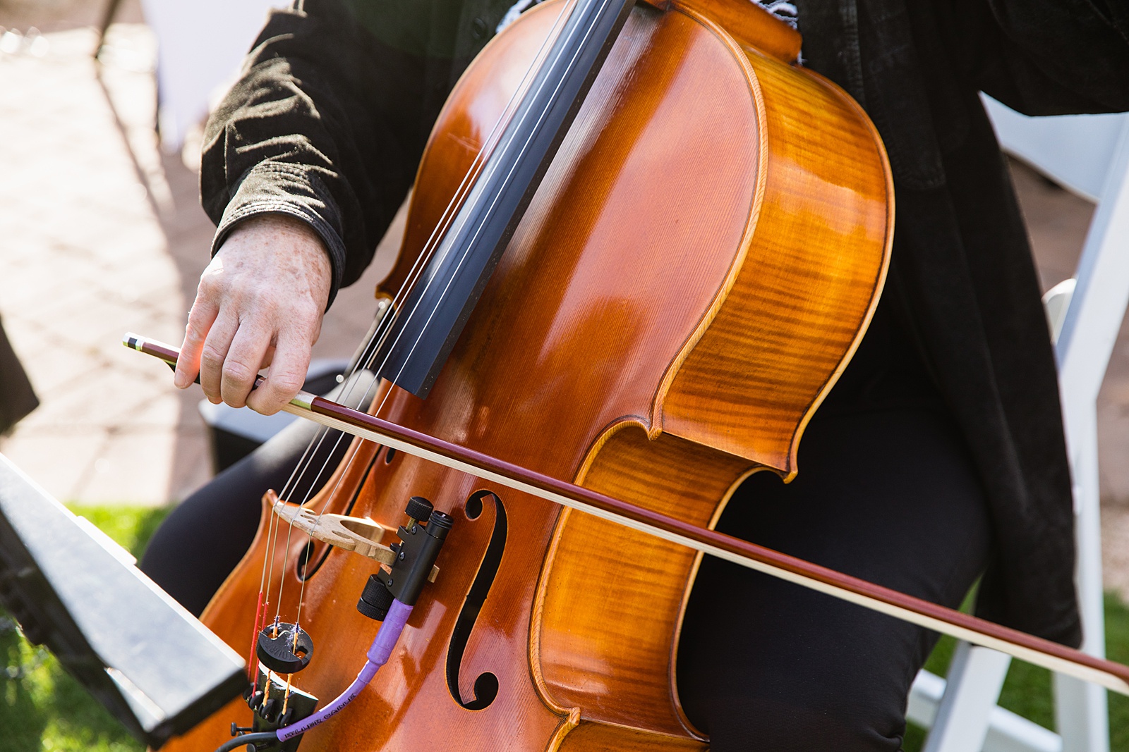 Close up image of ceremony musicians playing a cello at a Troon North wedding by Scottsdale wedding photographer PMA Photography.