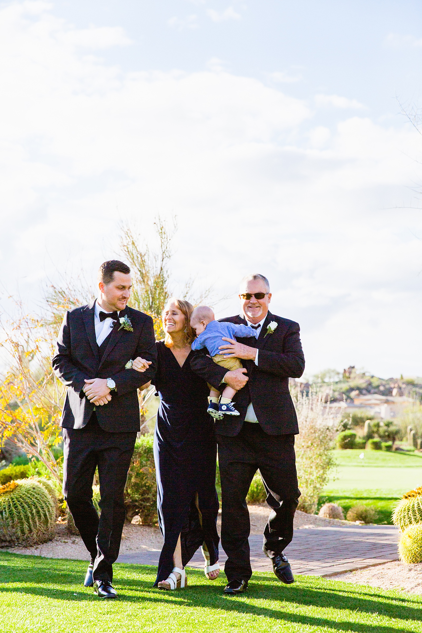 Groom walking down aisle during Troon North wedding ceremony by Phoenix wedding photographer PMA Photography.