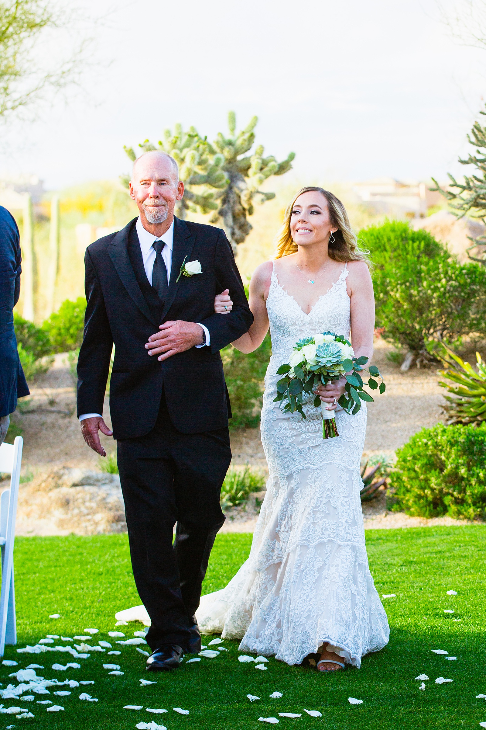 Bride walking down aisle during Troon North wedding ceremony by Phoenix wedding photographer PMA Photography.