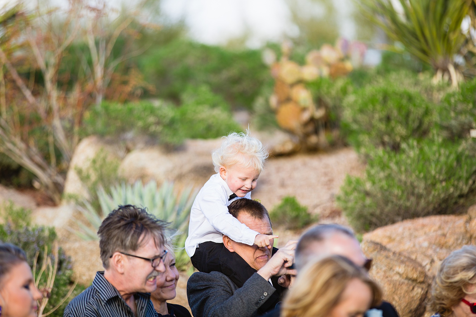 Wedding guests watching the wedding ceremony at Troon North by Scottsdale wedding photographer PMA Photography.