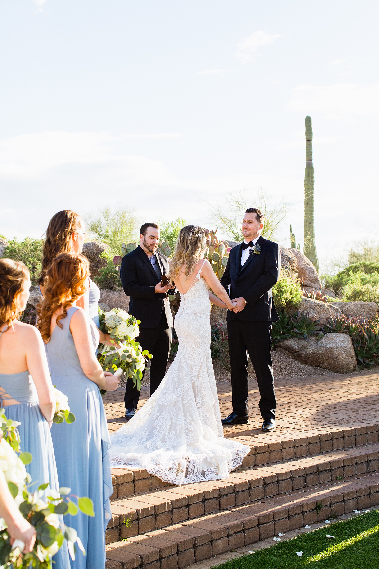 Groom looking at his bride during their wedding ceremony at Troon North by Scottsdale wedding photographer PMA Photography.