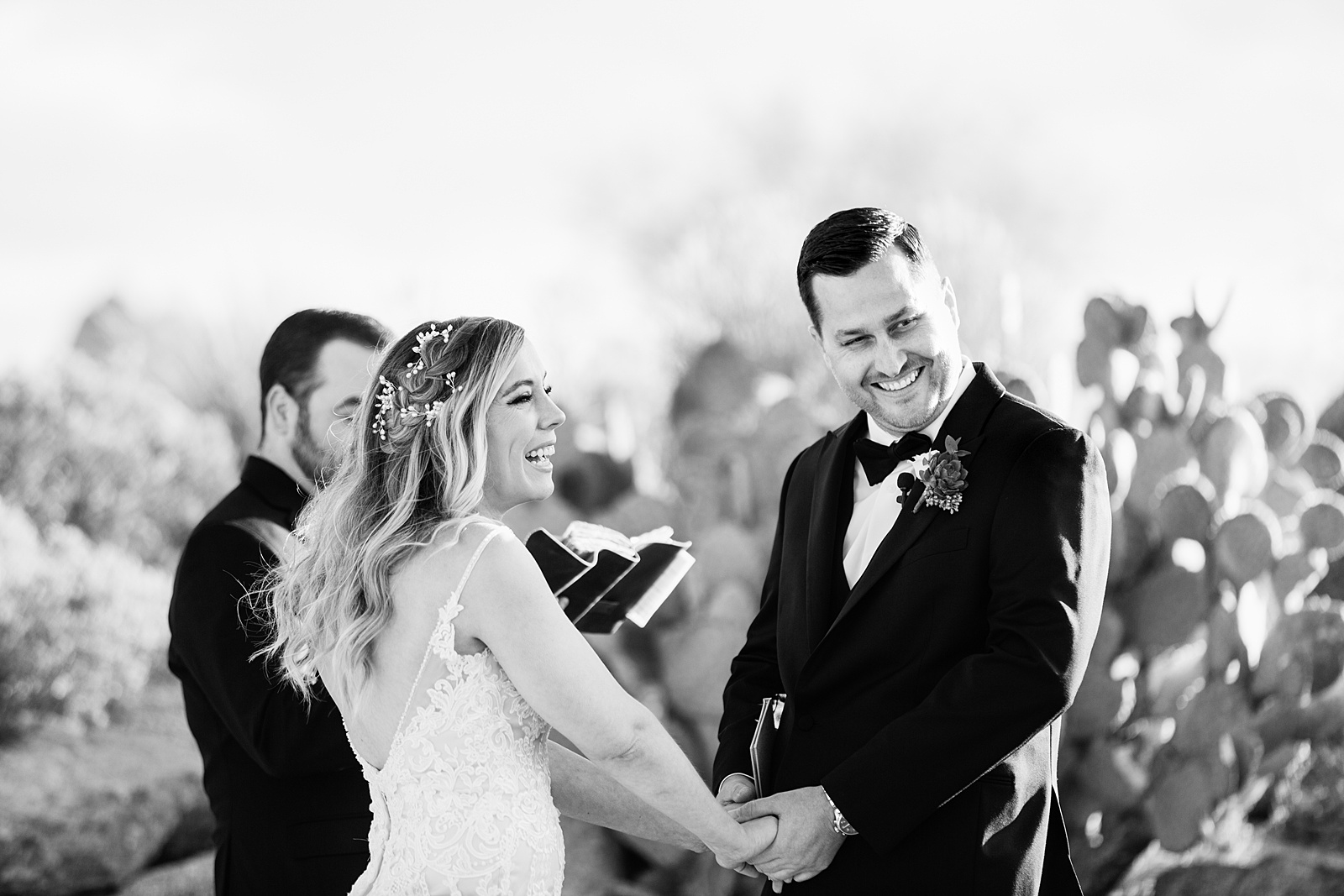 Bride and groom laughing together during Troon North wedding ceremony by Scottsdale wedding photographer PMA Photography.