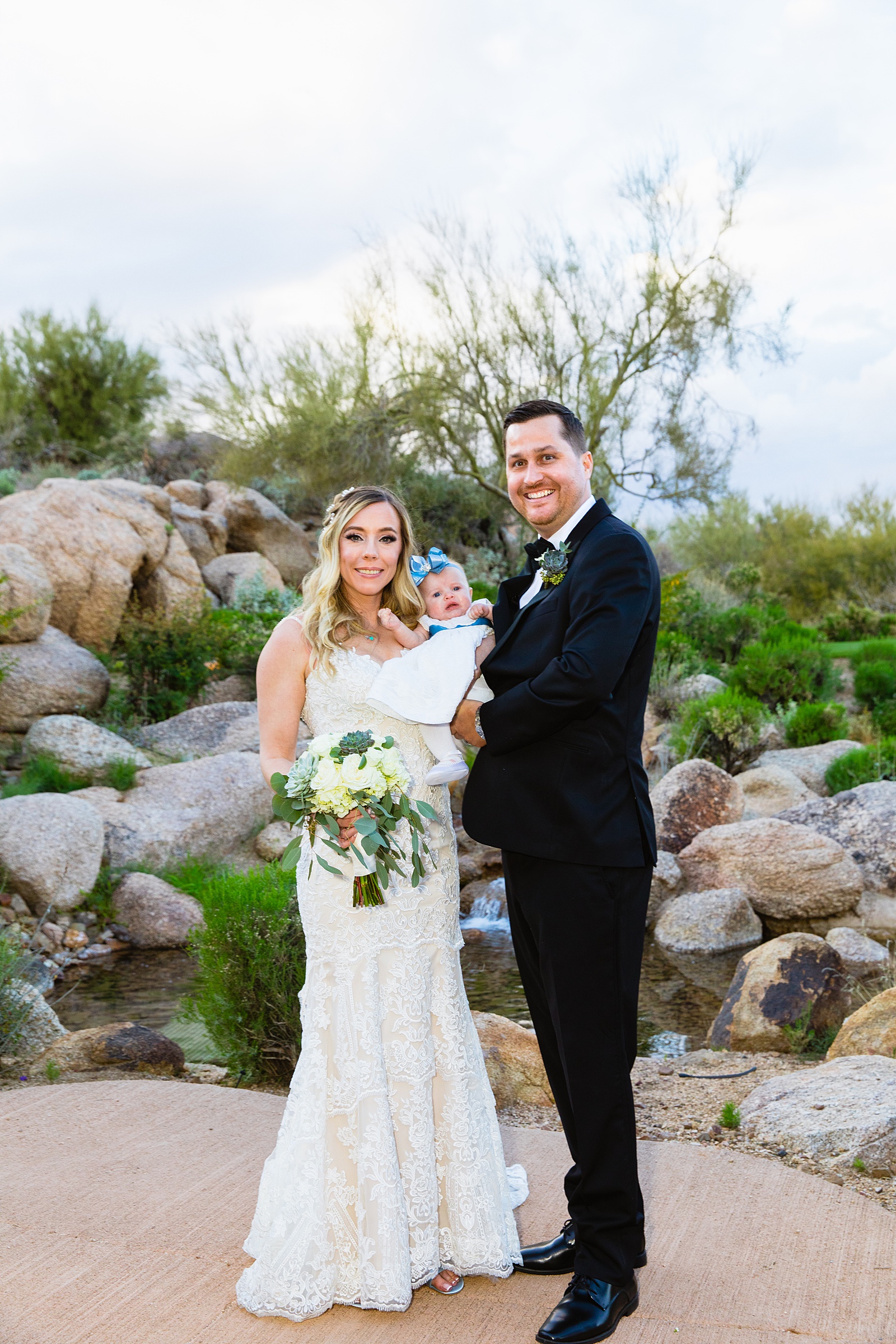 Bride and groom pose with family during their Troon North wedding by Arizona wedding photographer PMA Photography.
