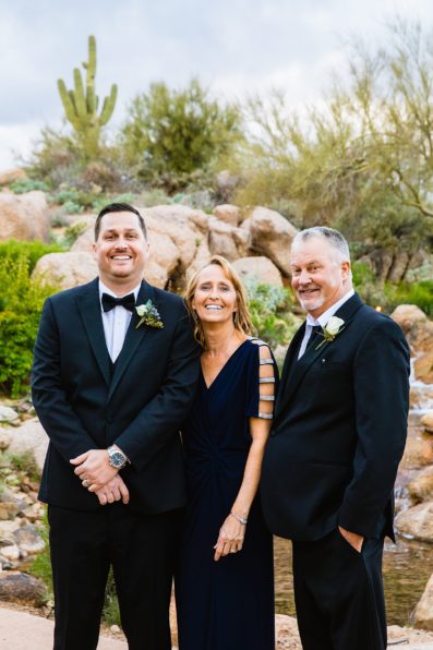 Bride and groom pose with family during their Troon North wedding by Arizona wedding photographer PMA Photography.